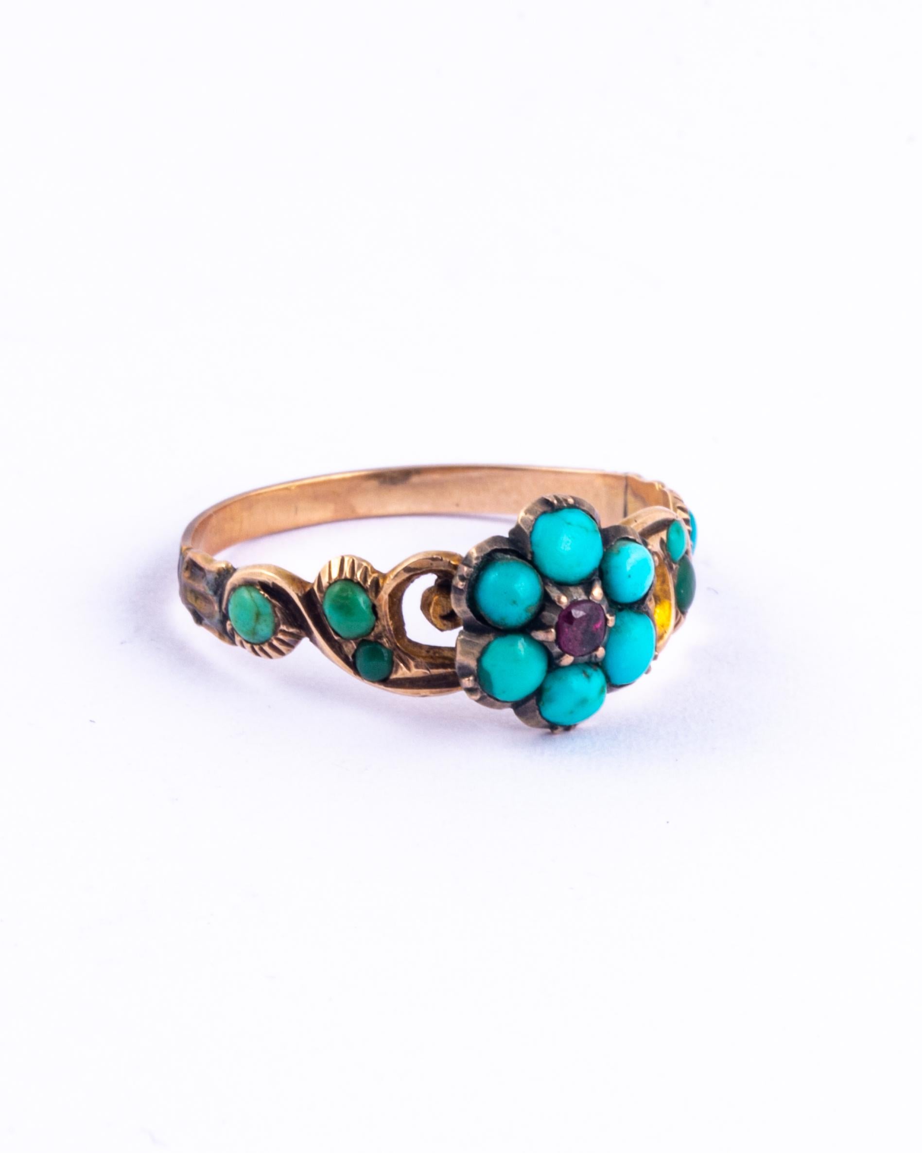 This beauty has an incredibly decorative 18ct gold shank. Sat on top of the swirling detail is a cluster of six bright turquoise and a gorgeous ruby in the middle. The shoulders also hold smaller turquoise. 

Ring Size:  O or 7 1/4 
Cluster