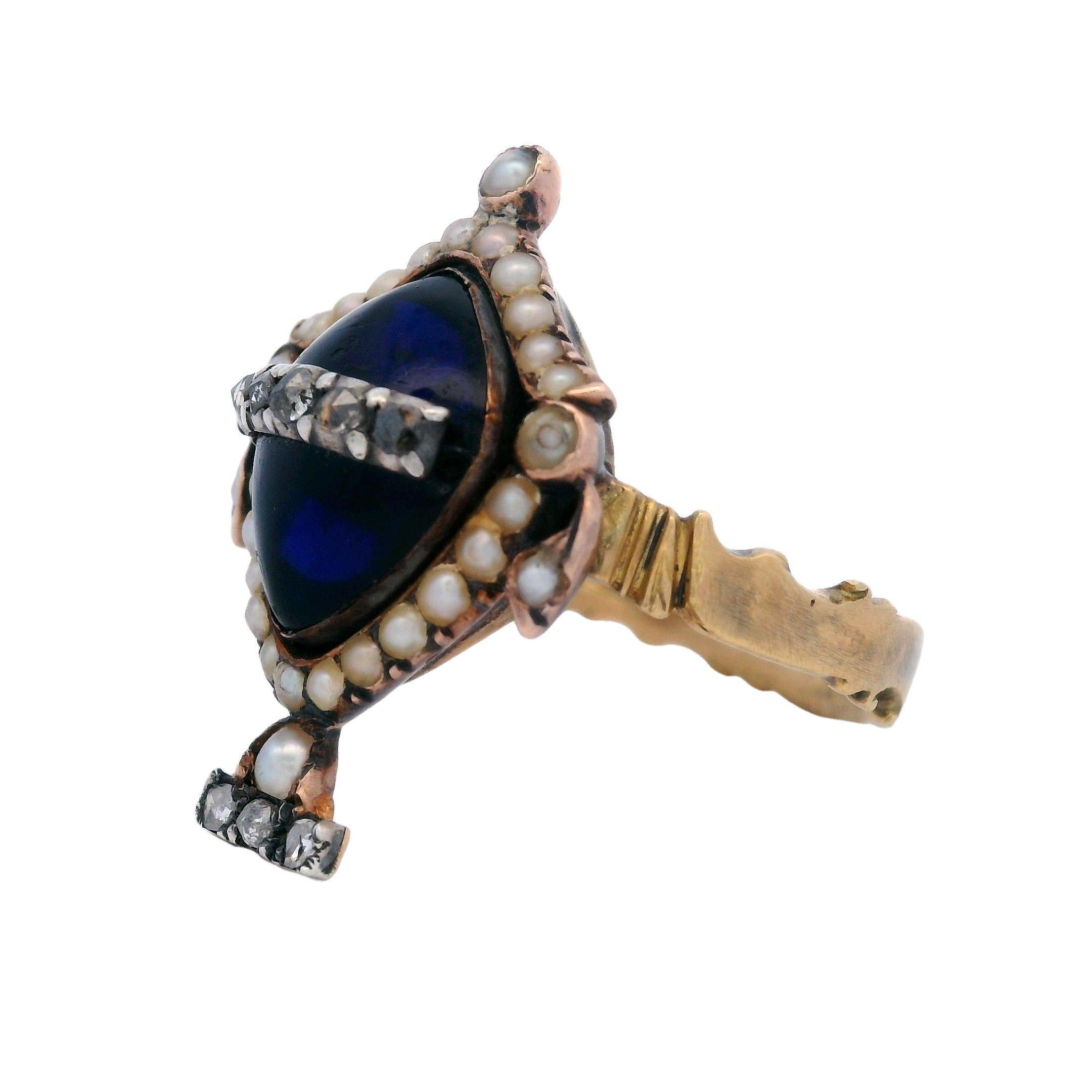 Georgian Urn Mourning Ring with Synthetic Sapphire and Diamonds in 18K Gold

This Georgian Urn Mourning Ring, crafted in the early 19th century, is a beautiful representation of both elegance and heritage. Made from 18k gold with silver and yellow