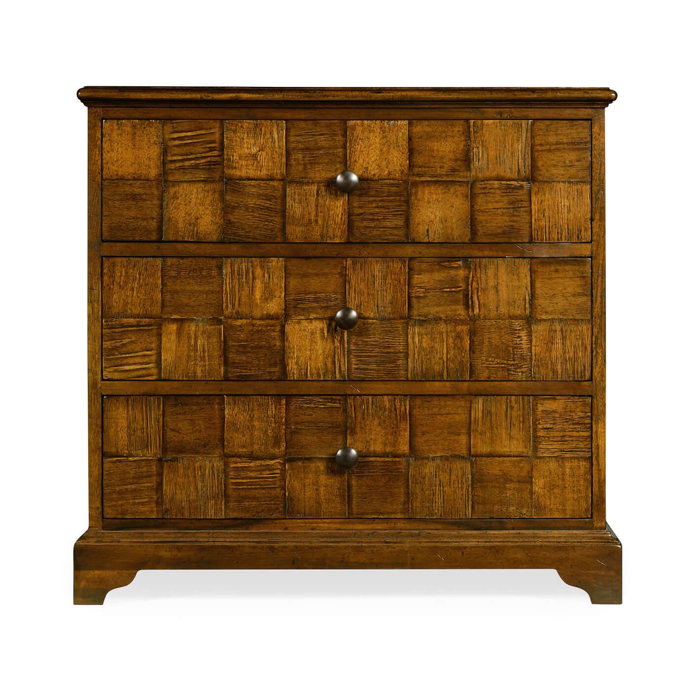 An English Georgian style rustic walnut finish three drawer chest of drawers with a molded edge top, crosshatched pattern drawer fronts on a stepped bracket foot base.

Dimensions: 31.75