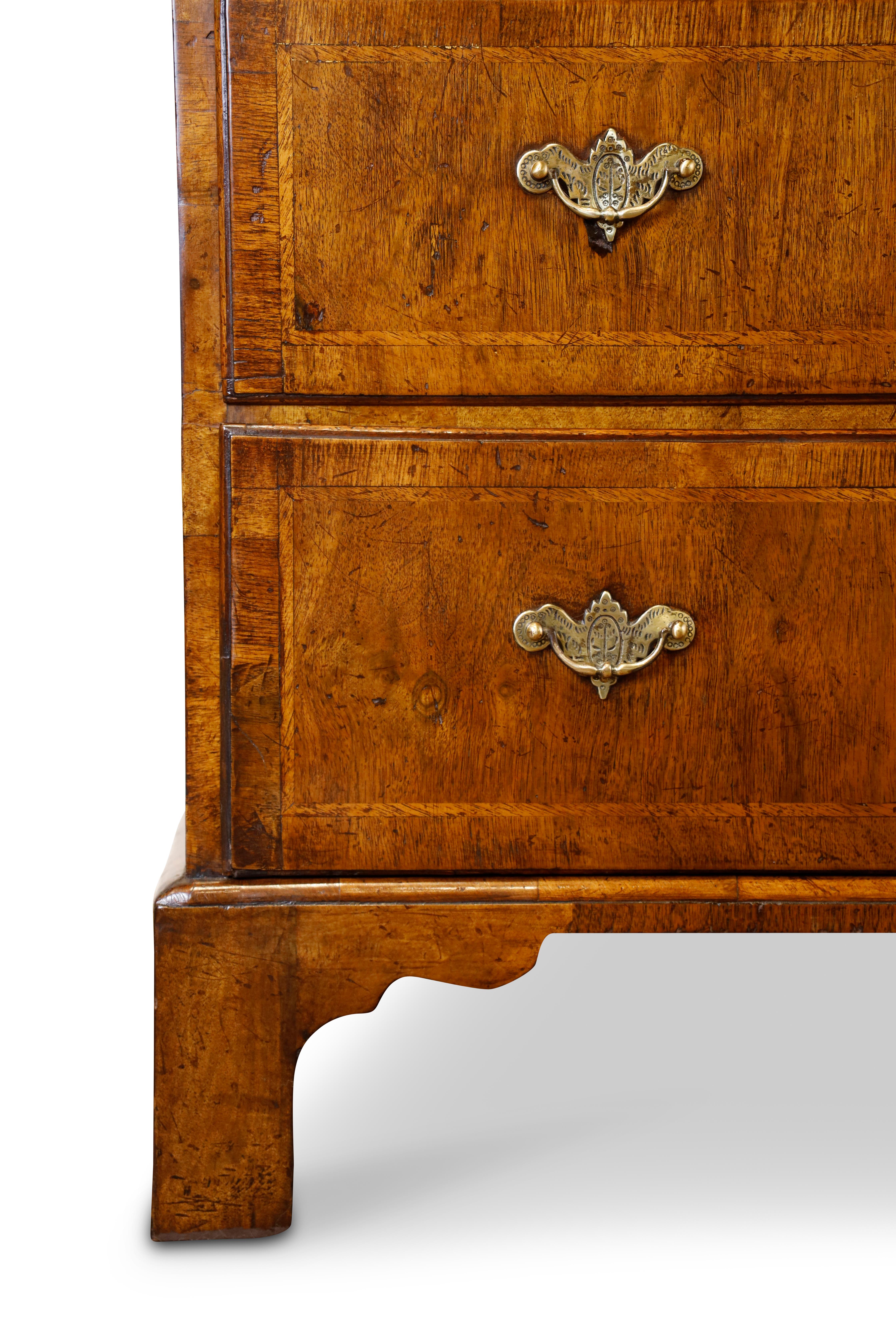 Georgian walnut and oak chest on chest.  Upper section consists of three over three graduated drawers, reeded chamfered corners and deep crown moulding.  Bottom section stands on bracket feet and features three graduated drawers with the bottom