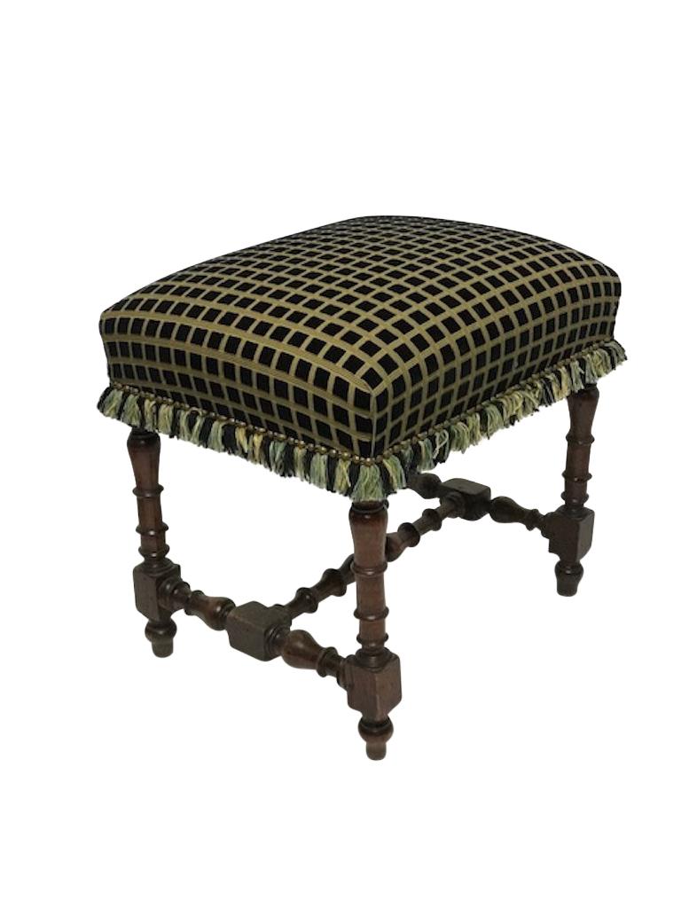 Georgian period walnut bench or stool with turned legs and stretchers, having and upholstered seat with tassel trim, England, circa 1780.