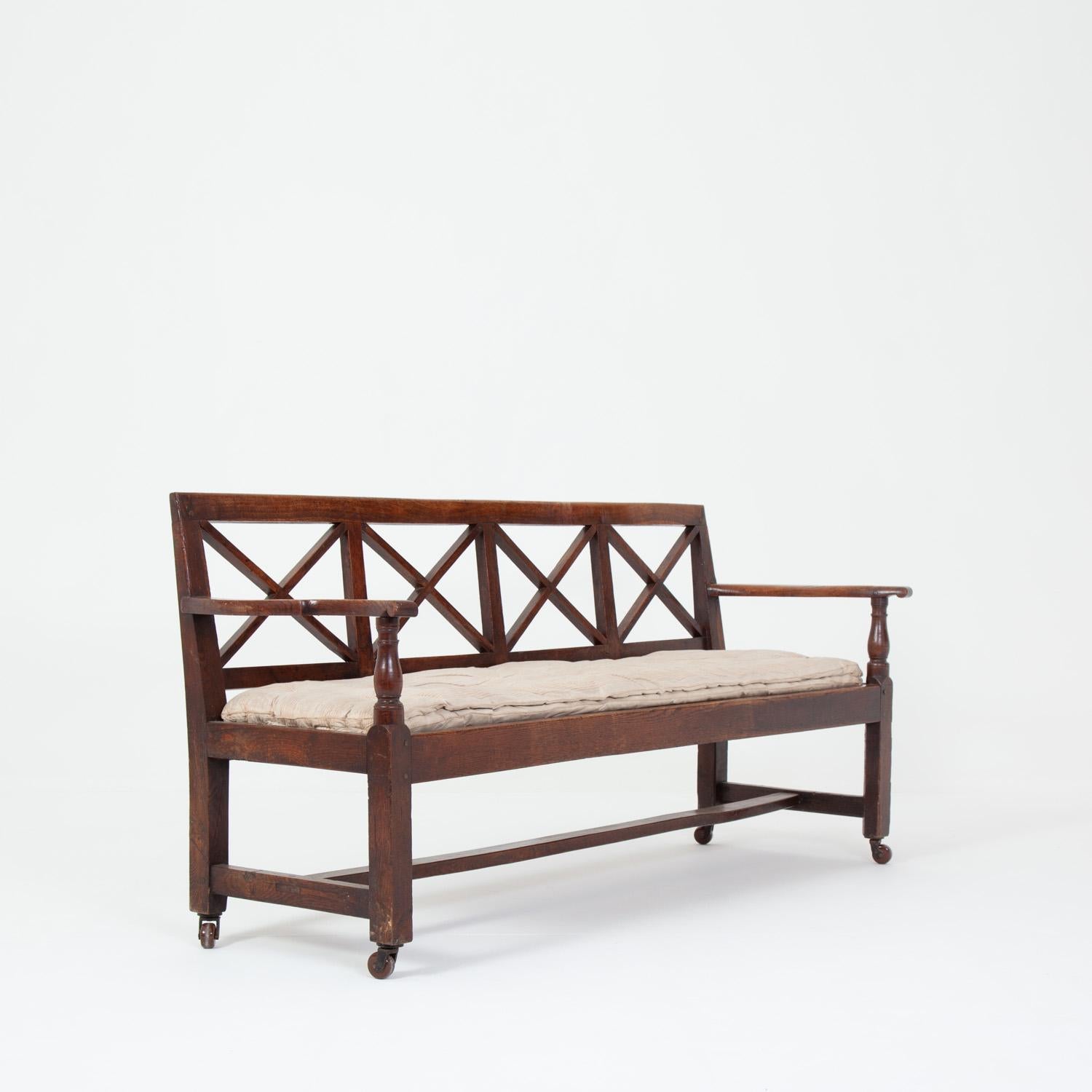 Hugely attractive unusual Westmorland bench on casters.

Sturdy and strong, in great condition for a late Georgian piece with a lovely patina.

The original seat was replaced with old springs at some point in the bench’s history, which makes for a