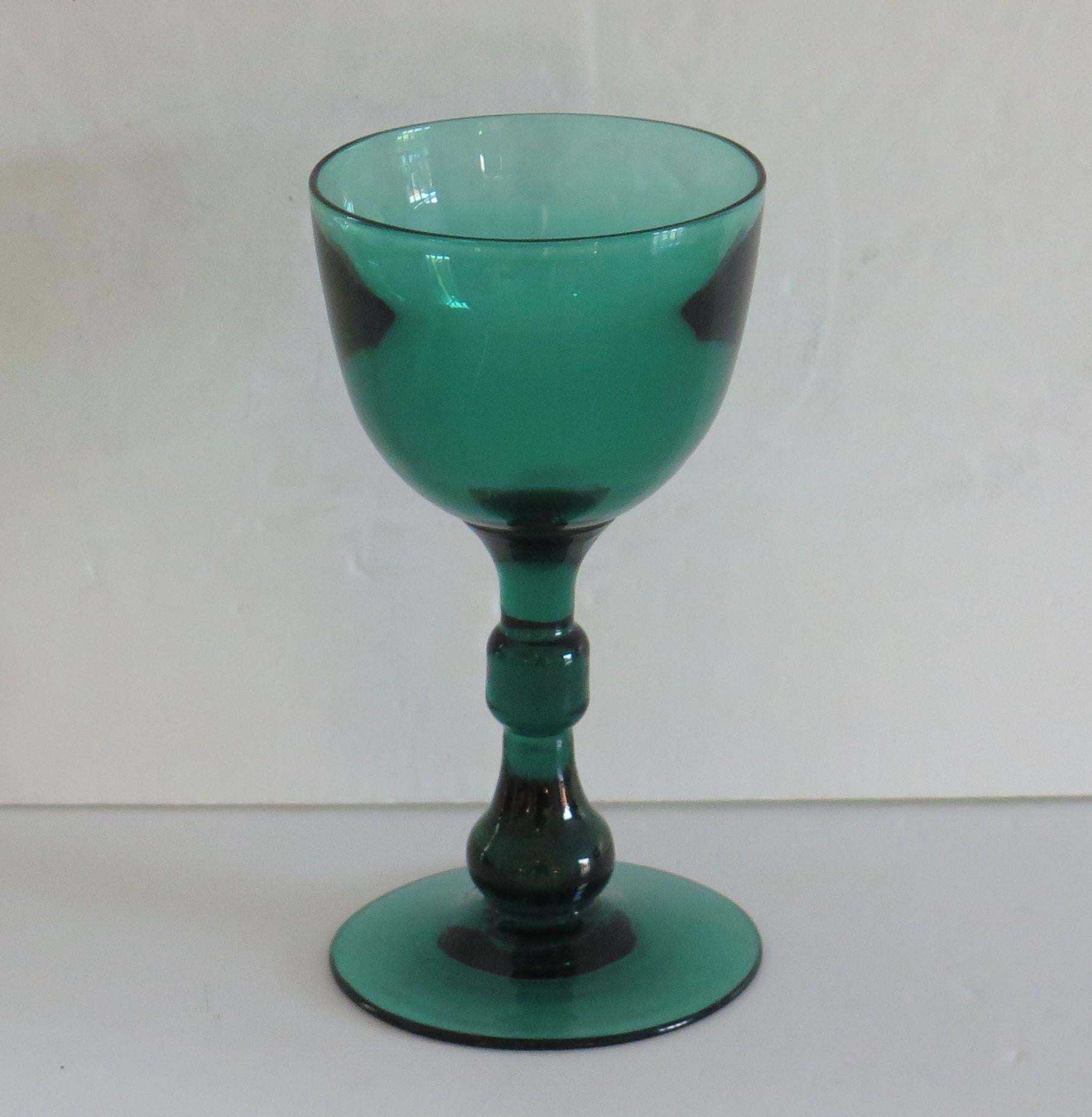 This is an excellent example of an early 19th century, English, hand blown, Bristol green wine drinking glass which we date to the George 111rd Regency period, circa 1815.

This glass has an elegant open round funnel bowl with a very interesting