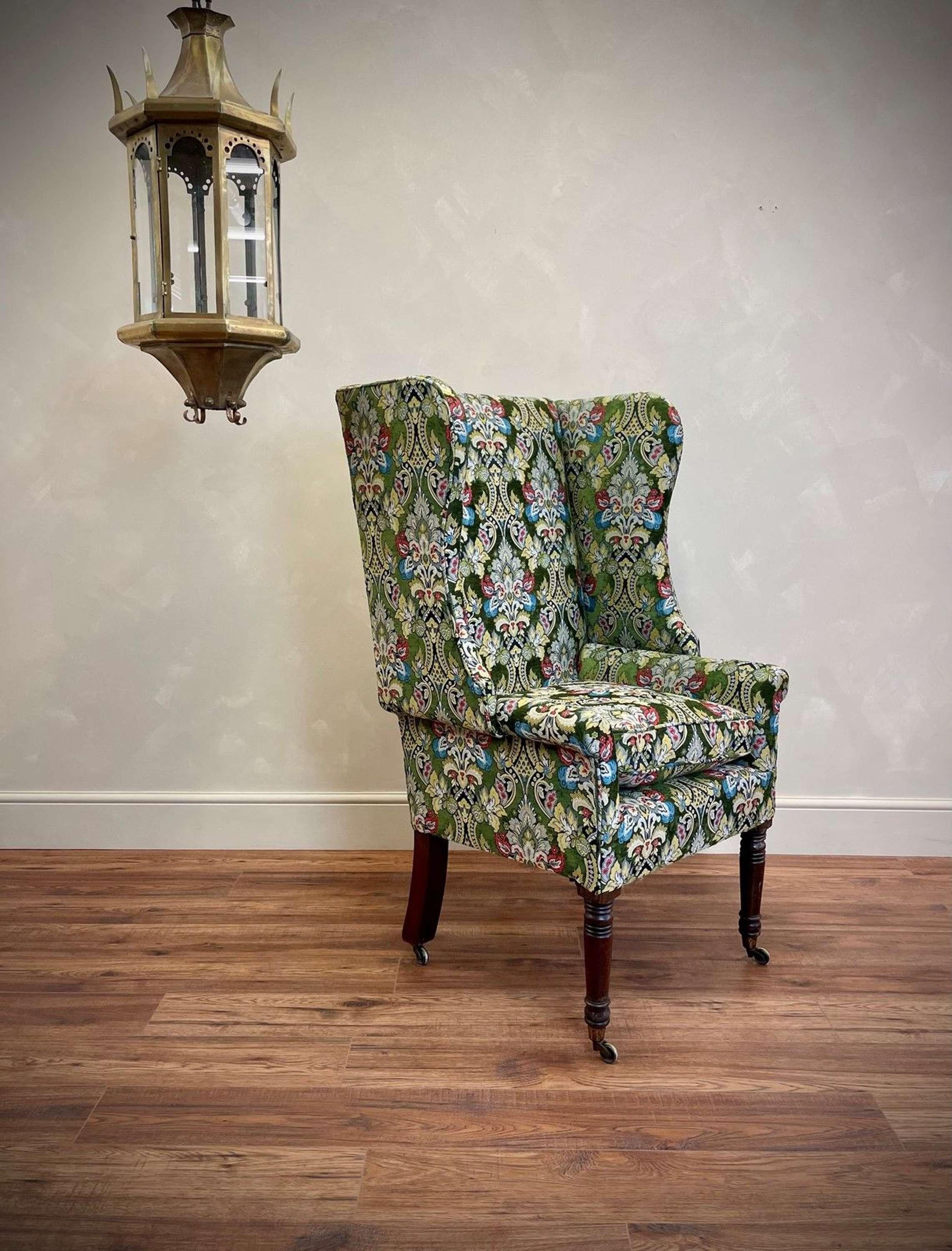 Expert upholstery job on this hi-back Georgian winged chair with epic form and proportions.
The tall, turned front legs with casters add to its grandeur.
Pure quality tapestry and chenille fabric, which also covers a plump, feather filled seat