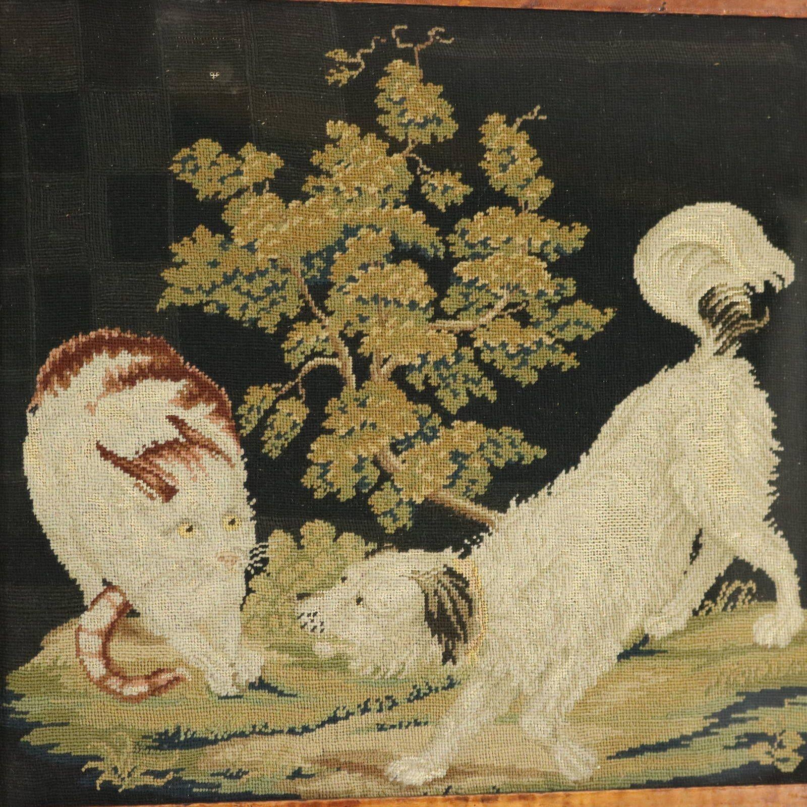 Georgian Woolwork Embroidery of Dog & Cat. The piece is worked in tent stitch, using silk and wool thread. Colours black, green, white, silver and brown. Subject depicts an animated dog and cat in a country landscape, with a tree in the background.