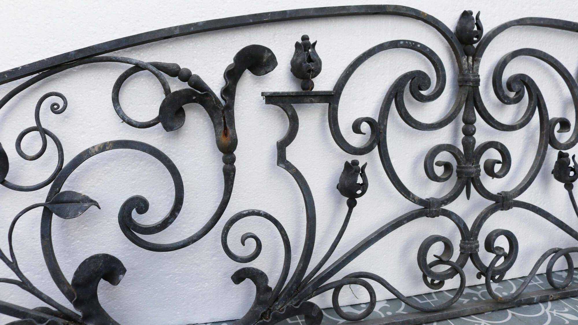 Ornately decorated, this wrought iron gate overthrow is a beautiful way to make a statement at the entrance to a garden or courtyard. It dates from the late 19th century and is in very good condition, galvanised and finely hand worked with flowers,