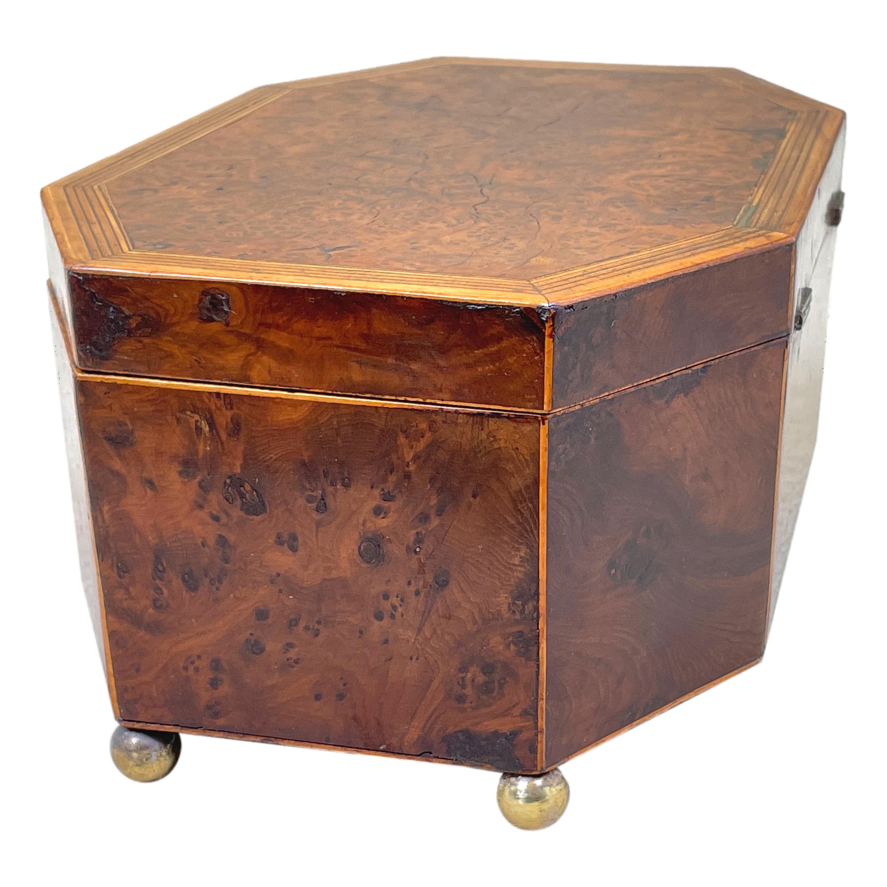 A very elegant George III period octagonal shaped burr yew wood jewellery box having attractive banded inlaid decoration to hinged lid enclosing lined interior raised on original brass ball feet. 

Just the right size for a bedside table or
