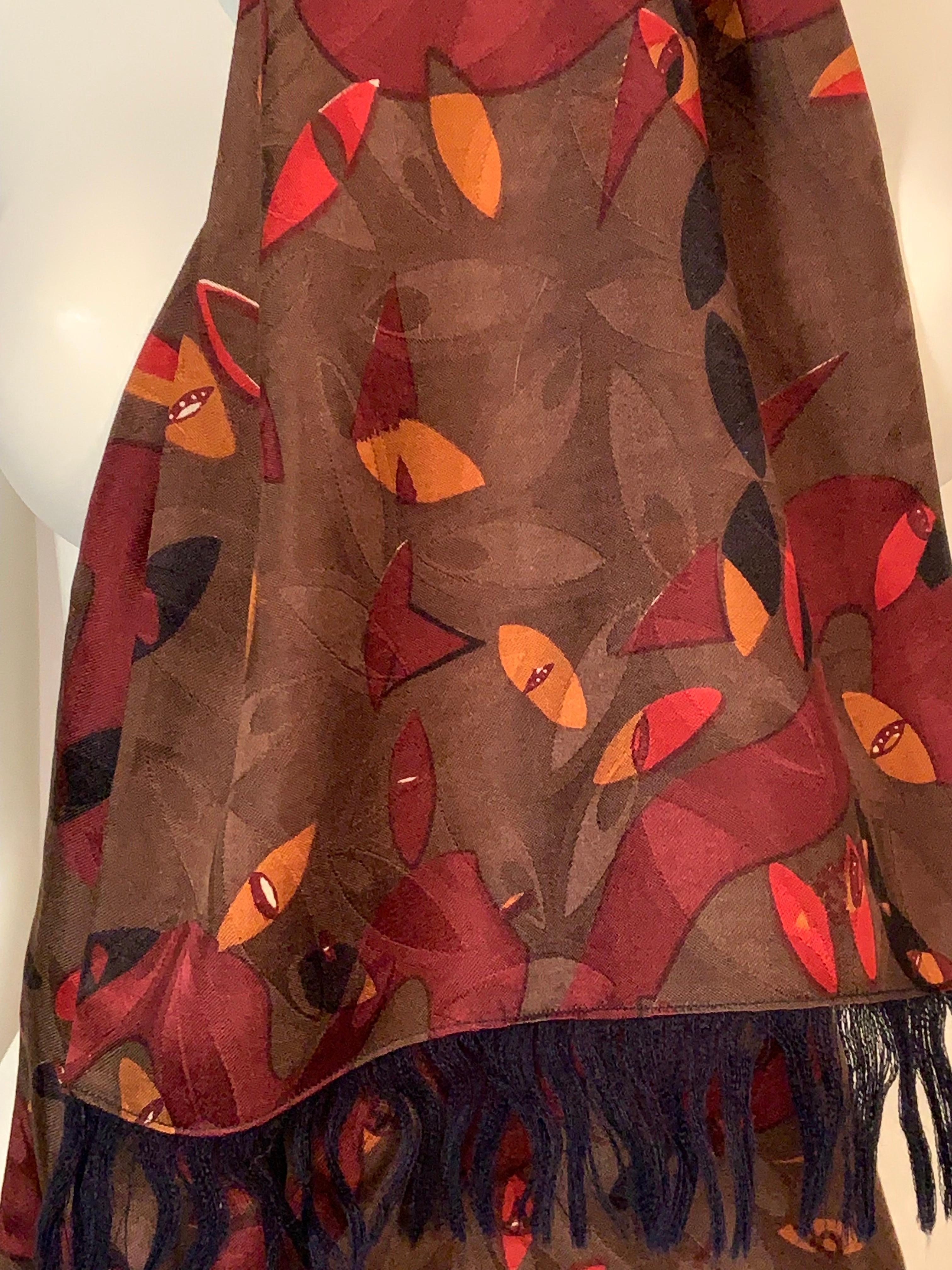 This reversible scarf is from the Georgina von Etzdorf archives and it has never been worn. The silk side has a Modernist print in burgundy, black, mustard, and white on a cocoa brown woven silk background.  The reverse side is navy blue wool with