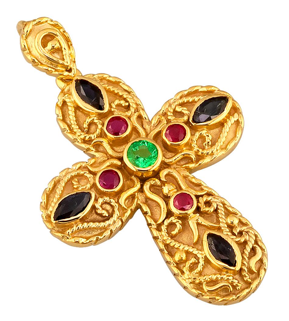 This S.Georgios Designer Byzantine Style Cross Pendant Enhancer is handmade from solid 18 Karat Yellow Gold and features 4 Rubies, 4 Sapphires, and an Emerald center with all total weight of 1.05 Carat. This stunning art piece is made as an