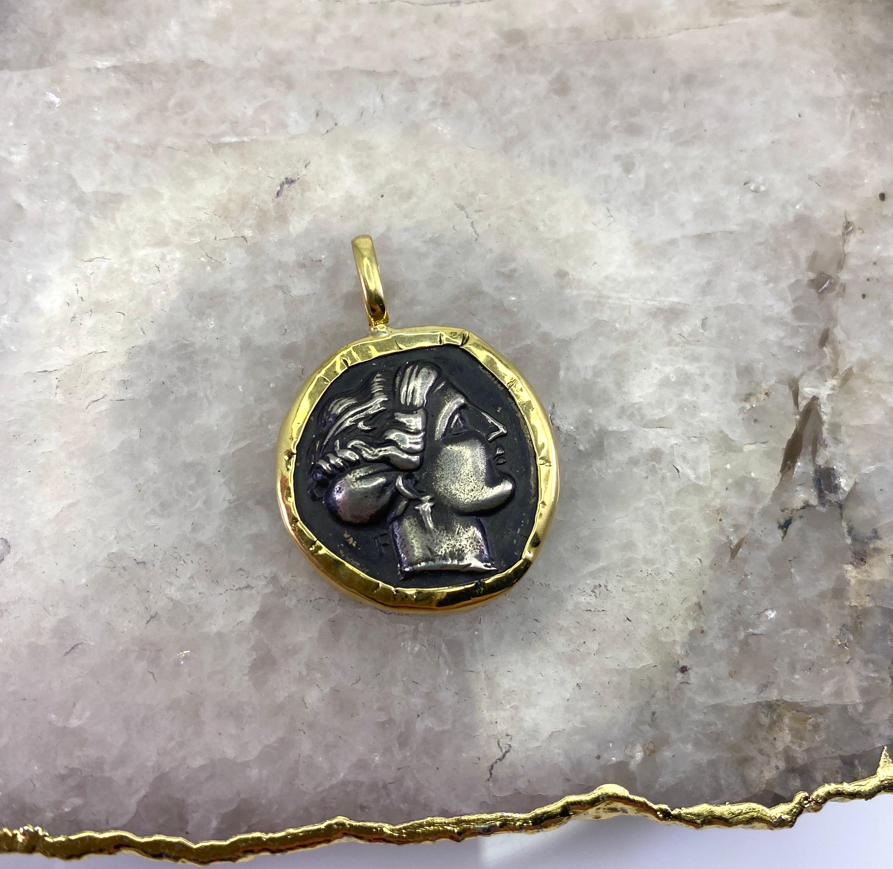 This S.Georgios designer 18 Karat Yellow Gold handmade Pendant Necklace pictures face of Olympia, the Greek Princess and mother of Alexander the Great imprinted in 925 Silver Coin. The coin is a replica of an Ancient coin. The rim and hook of the