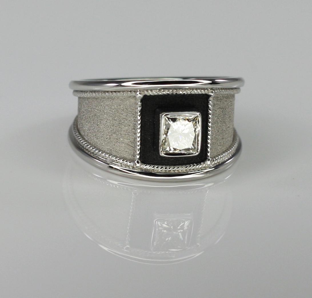 S.Georgios design ring handmade from solid 18 Carat White Gold and decorated with granulation and Byzantine velvet background. The square front area surrounding the diamond is finished in Black Rhodium. This gorgeous unisex ring features 0.75 Carat