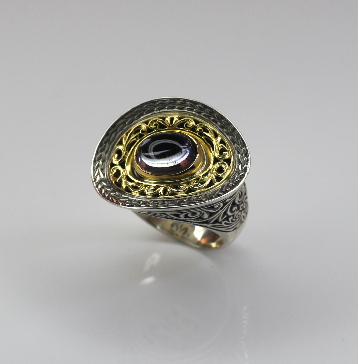 Georgios Collections designer asymmetrical oval all handmade heavy decorated two-tone ring crafted from sterling silver, solid 18 Karat yellow gold and finished with a black Rhodium background to create a unique look. 
The stunning ring features a