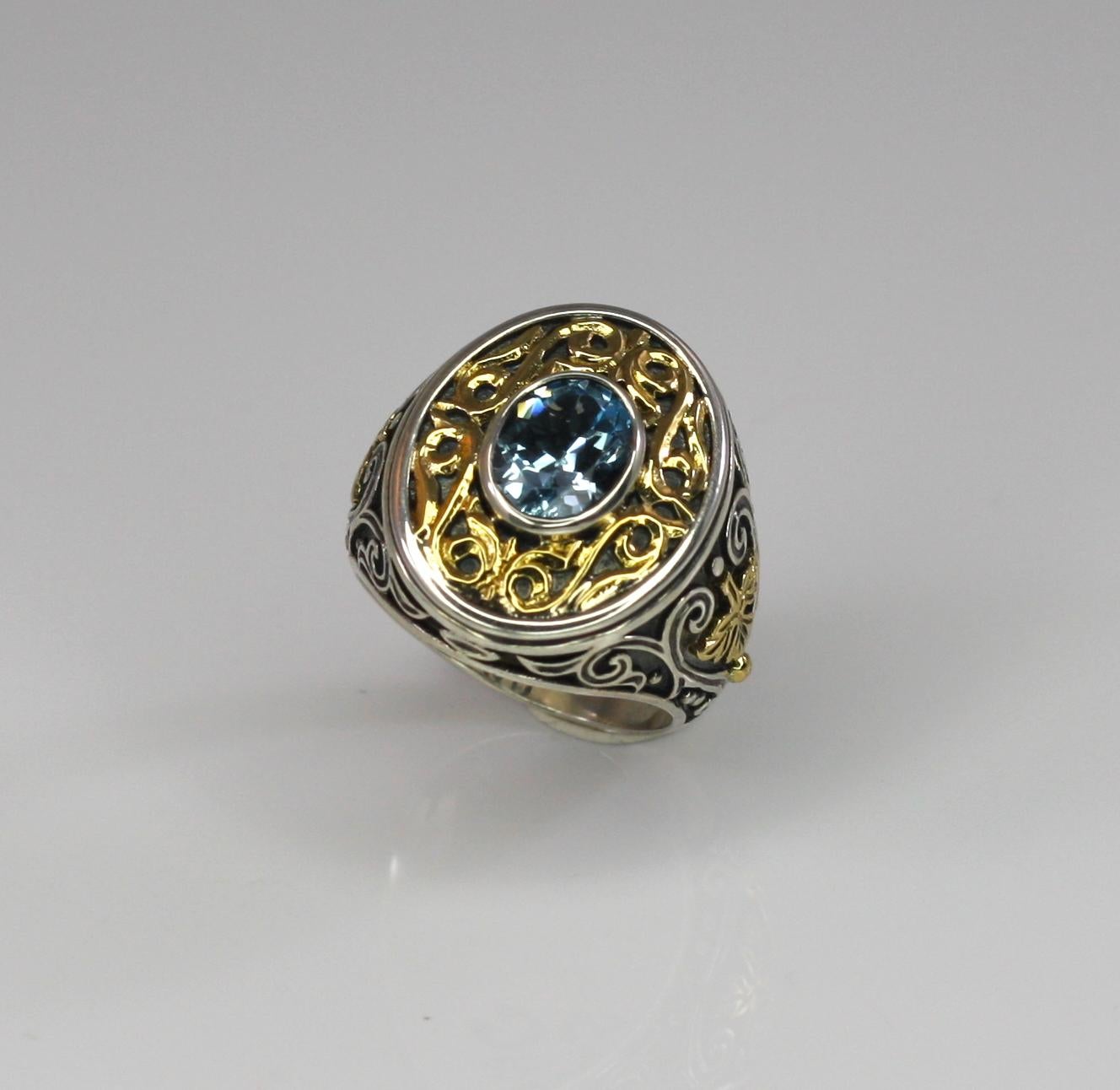 S.Georgios designer oval all handmade band ring, crafted from sterling silver and solid 18 Karat yellow gold inlay parts to create a unique look. This gorgeous art piece features a 3.80 Carat Blue Topaz. 
Please contact us for this design in a