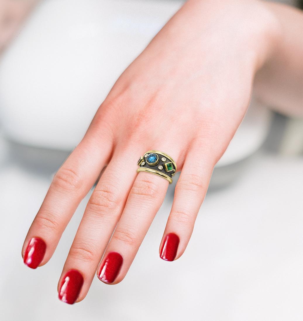 This gorgeous S.Georgios designer ring is handmade from solid 18 Karat Yellow Gold and is decorated with granulation details - beads and twisted wires. The velvet background in Byzantine style is finished with Black Rhodium. The ring features a 1.03