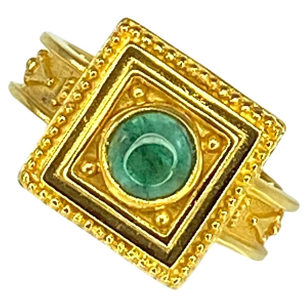 Presenting S.Georgios designer 18 Karat Solid Yellow Gold Ring all handmade with Byzantine Style workmanship in a square shape and decorated with granulation and a 0.38 Carat round Cabochon Emerald. This ring has a beautiful display and is amazingly