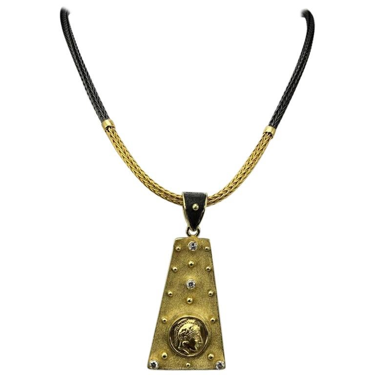 S.Georgios designer Coin Pendant is reversible and handmade from solid 18 Karat Yellow Gold. It is microscopically decorated on both sides with granulation - beads, and wires all from 22 Karat Gold. 
On one side it has Diamonds total weight of 0,14
