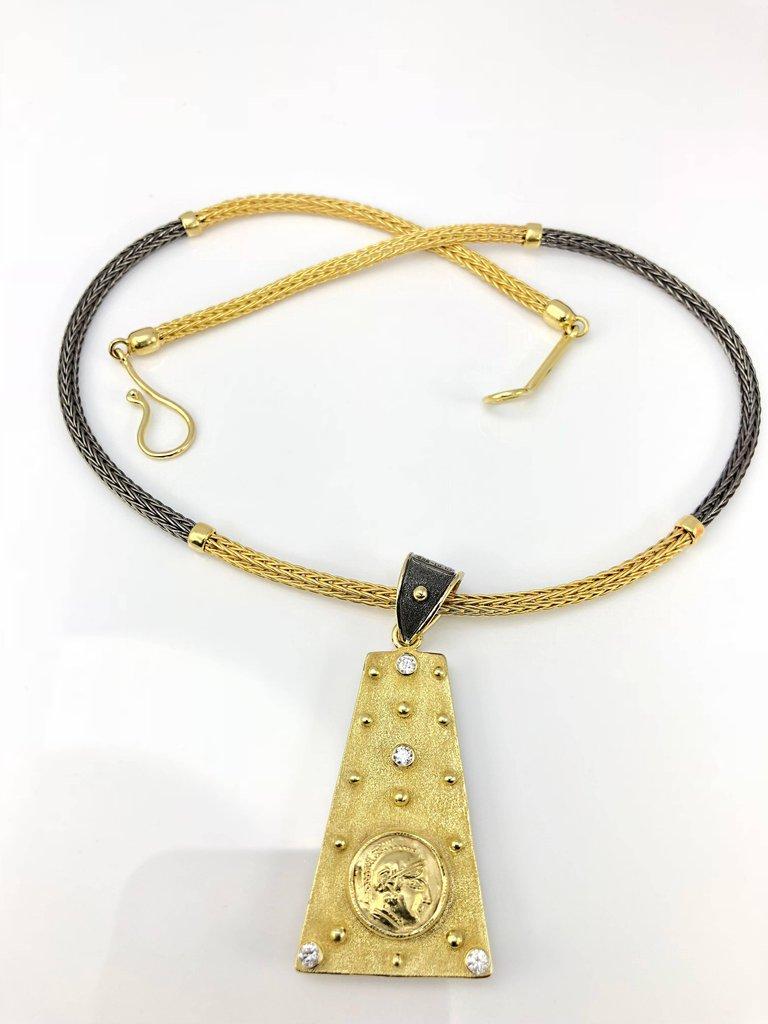 S.Georgios designer Coin Pendant is reversible and handmade from solid 18 Karat Yellow Gold. It is microscopically decorated on both sides with granulation - beads, and wires all from 22 Karat Gold. 
On one side it has Diamonds total weight of 0,14