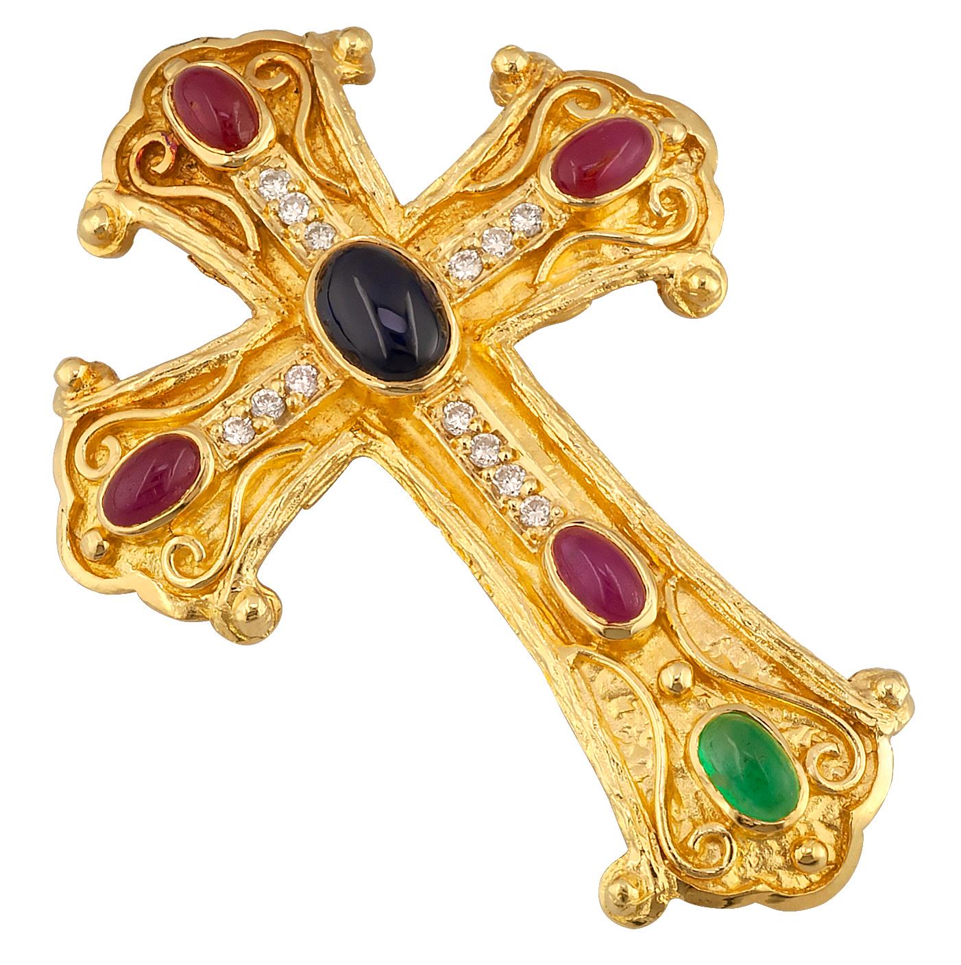 This S.Georgios Designer Byzantine Style Cross Pendant Enhancer is handmade from solid 18 Karat Yellow Gold and features diamonds total weight of 0.20 Carat, a cabochon Sapphire in the center, 4 Rubies, and an Emerald all total weight of 3,10 Carat.