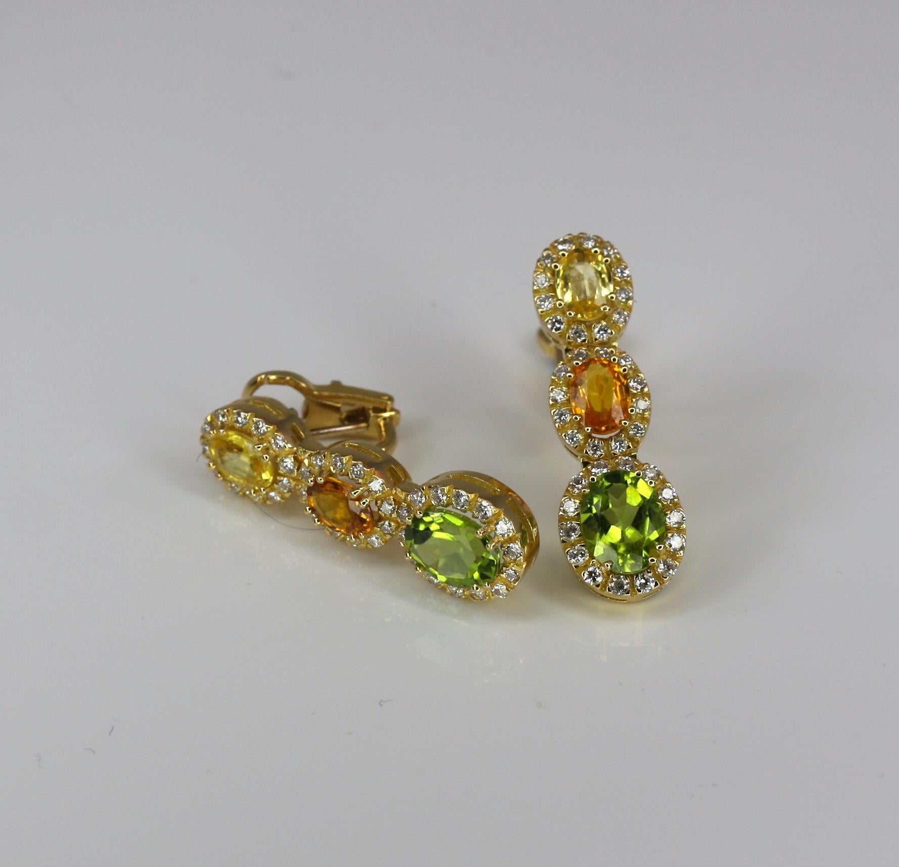 These dangle S.Georgios Earrings are 18 Karat yellow gold and all handmade. The earrings feature Yellow and Orange oval cut Sapphires, the total weight of 3.80 Carats and 4.40 Carat oval cut Peridots with Brilliant cut Diamonds, the total weight of