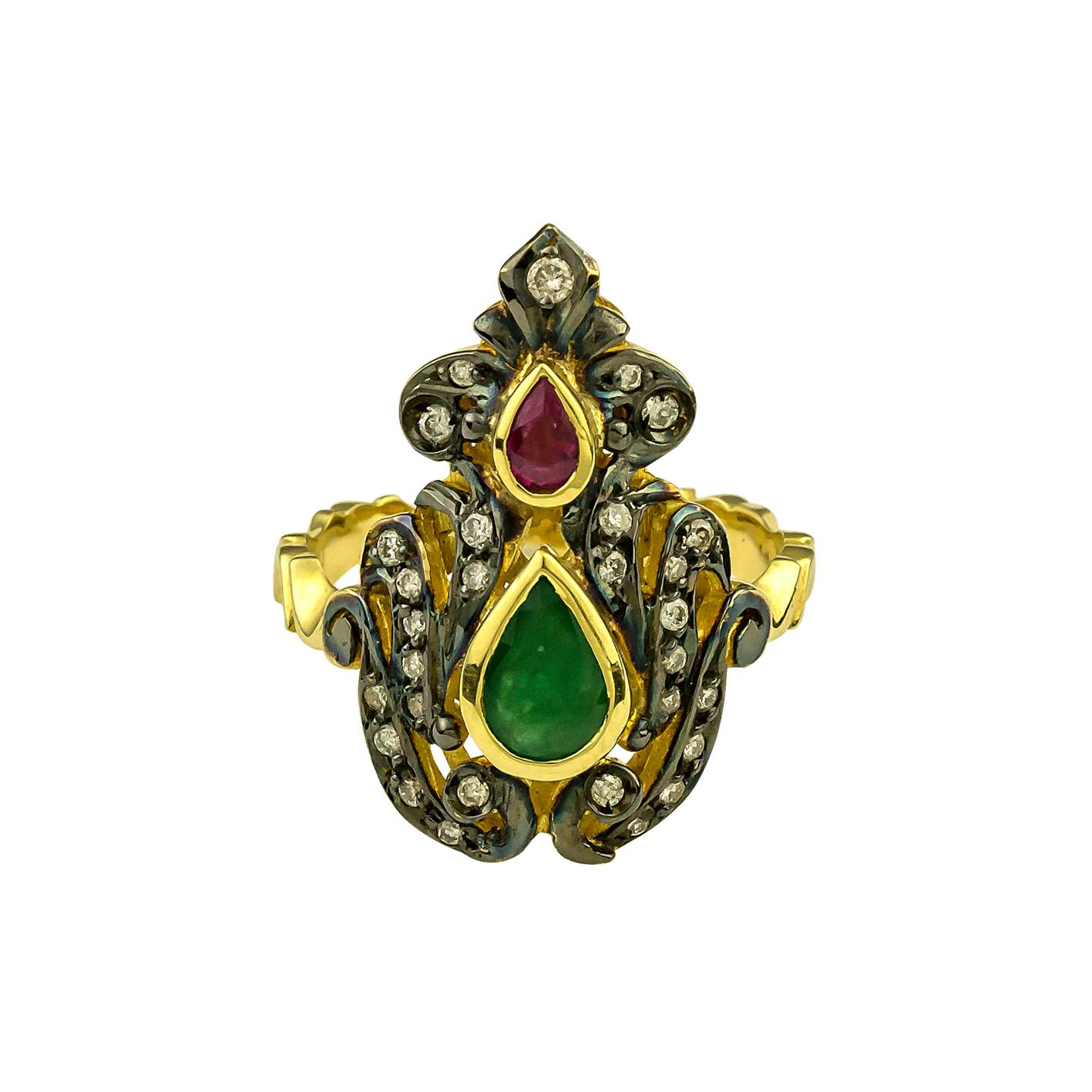 S.Georgios Hand Made 18 Karat Yellow Gold Ring decorated with Byzantine-style granulation and a combination of Diamonds, a Ruby, and an Emerald.
The stunning ring features Brilliant cut Diamonds with a total weight of 0,30 Carat, and a Ruby and an