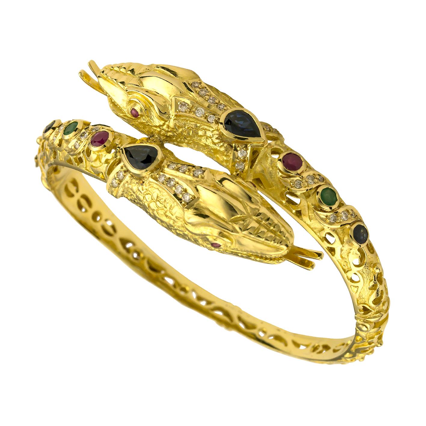 S.Georgios Snake Bracelet is handmade from solid 18 Karat Yellow Gold and is microscopically decorated with Granulated details. This unique bracelet features two Snakeheads with Rubies for eyes, inspired from the Byzantine museum,  Brilliant Cut