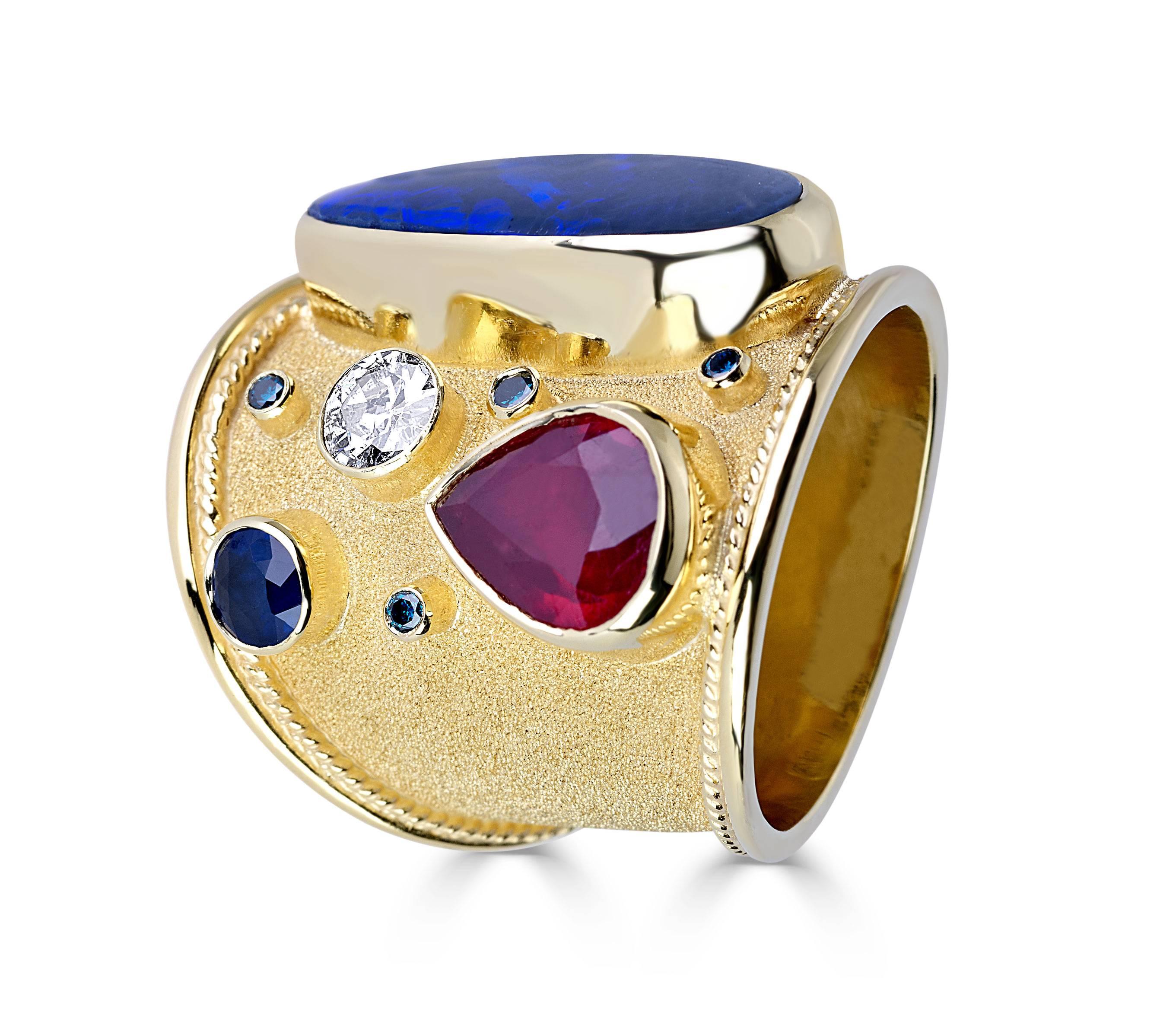 Unique S.Georgios designer 18 Karat Solid Yellow Gold Ring all handmade with Byzantine workmanship and a unique velvet background. This one-of-a-kind gorgeous ring features a 5.40 Carat Opal, 2.44 Carat Ruby, 0.50 Carat Sapphire, 0.38 Carat White