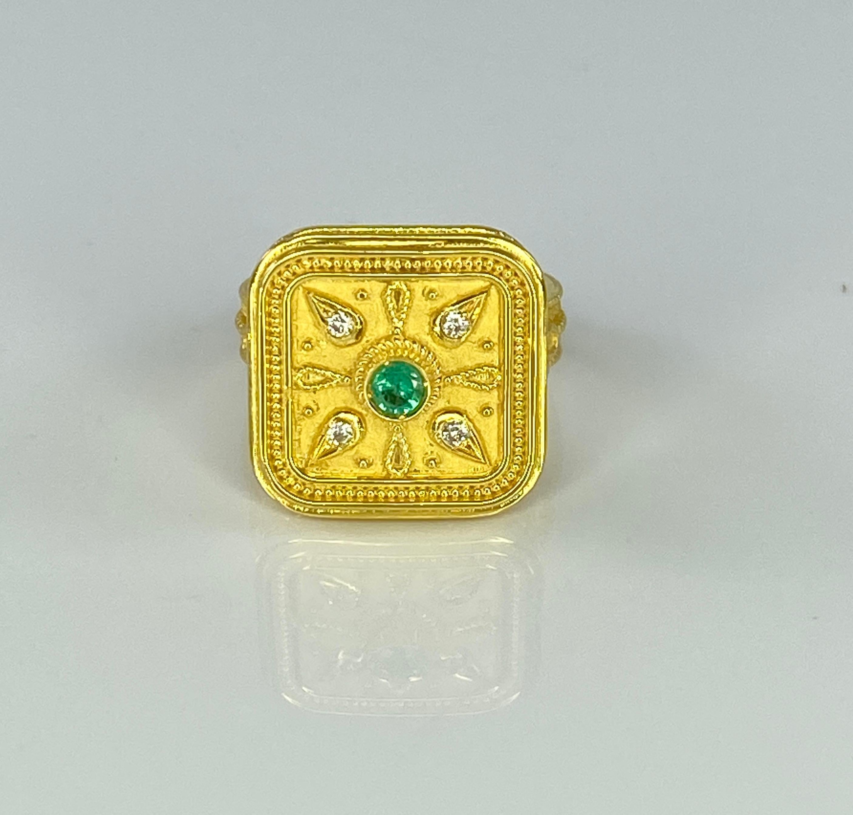 Presenting S.Georgios designer 18 Karat Solid Yellow Gold Ring all handmade with Byzantine Style workmanship where granulation and twisted wires stand out on a unique velvet background.  This ring is decorated with a 0.22-carat round Emerald center