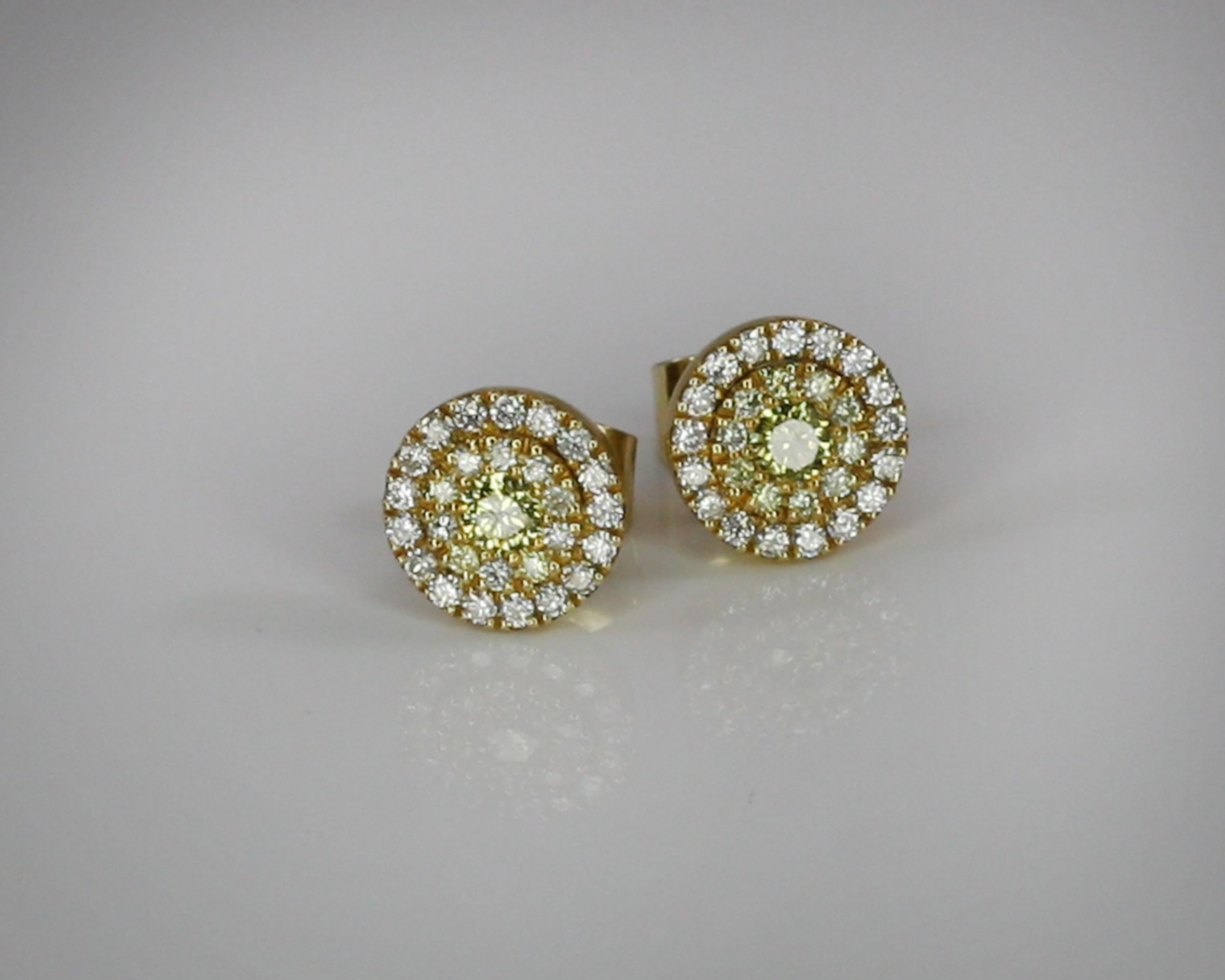 These S.Georgios designer stud earrings are hand made from 18 Karat Yellow Gold to create a classic and elegant look. These beautiful earrings feature in the center 2 brilliant-cut natural yellow Diamonds with a weight of 0.20 Carat, encircled in a