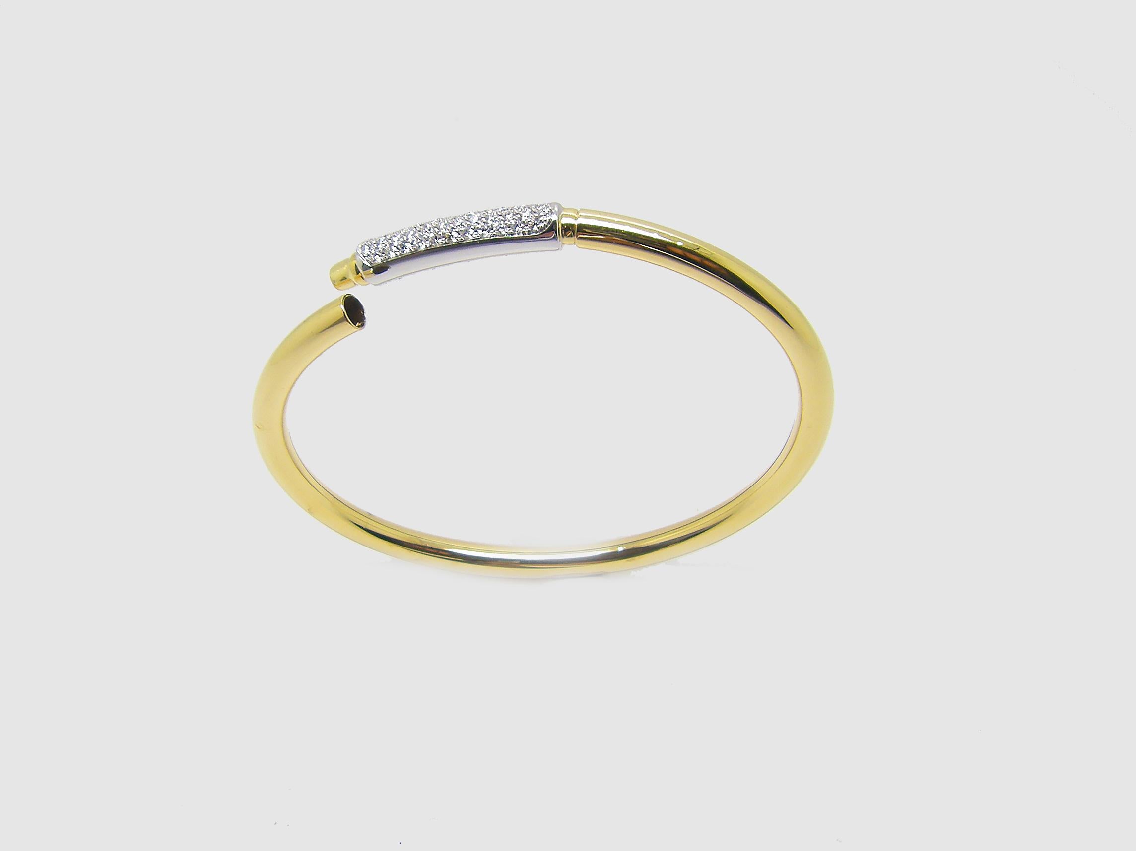 S.Georgios designer bangle cuff bracelet is custom made of Yellow and White gold 18 karats. The gorgeous bangle has brilliant cut white diamonds total weight of 0.44 Carat set microscopically on a bar of white gold 18 Karat and has a wonderful