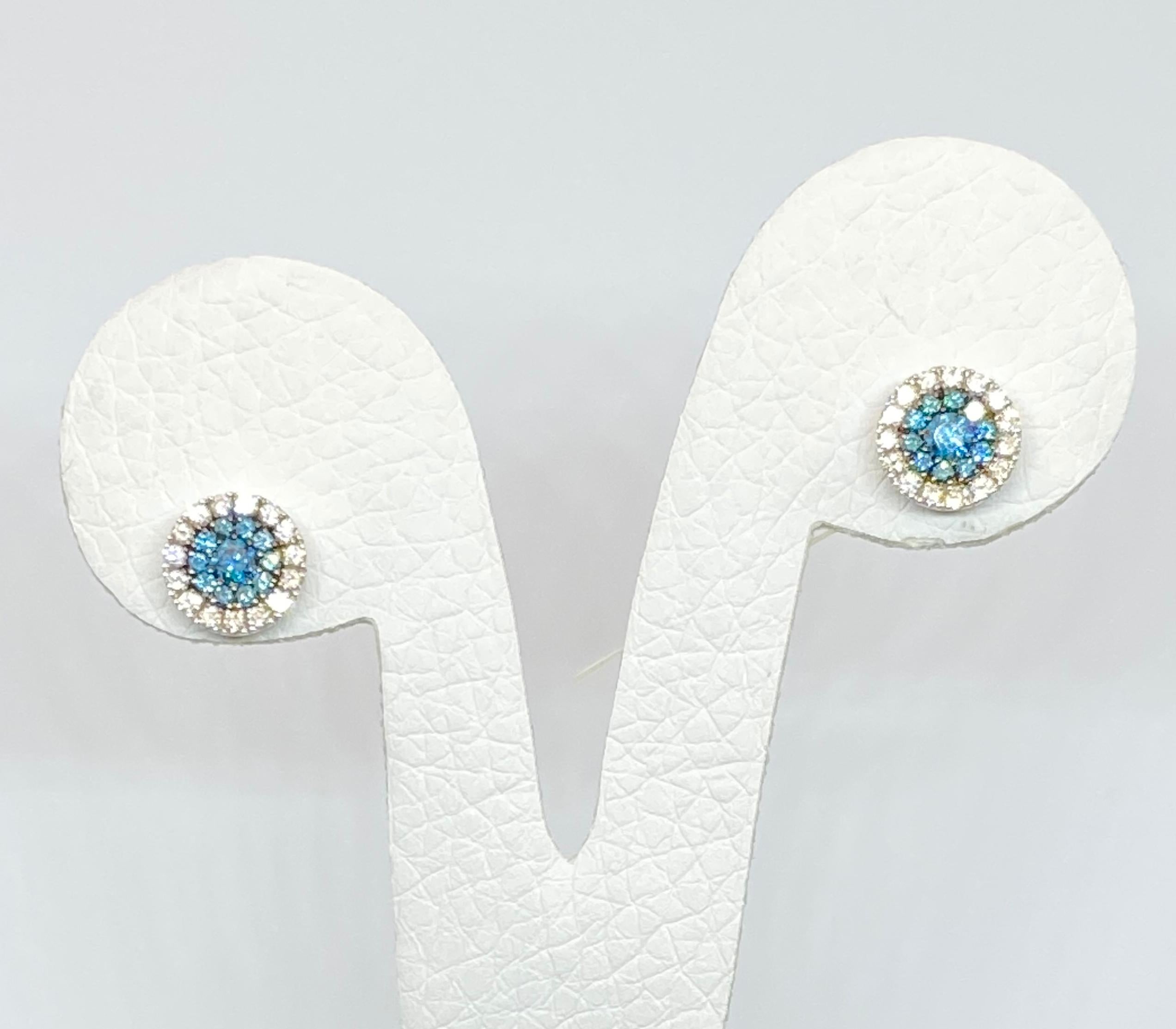 These S.Georgios designer stud earrings are hand made from 18 Karat Yellow Gold to create a classic and elegant look. These beautiful earrings feature a center brilliant cut Blue Diamond, surrounded by 20 Blue diamonds all with a total weight of