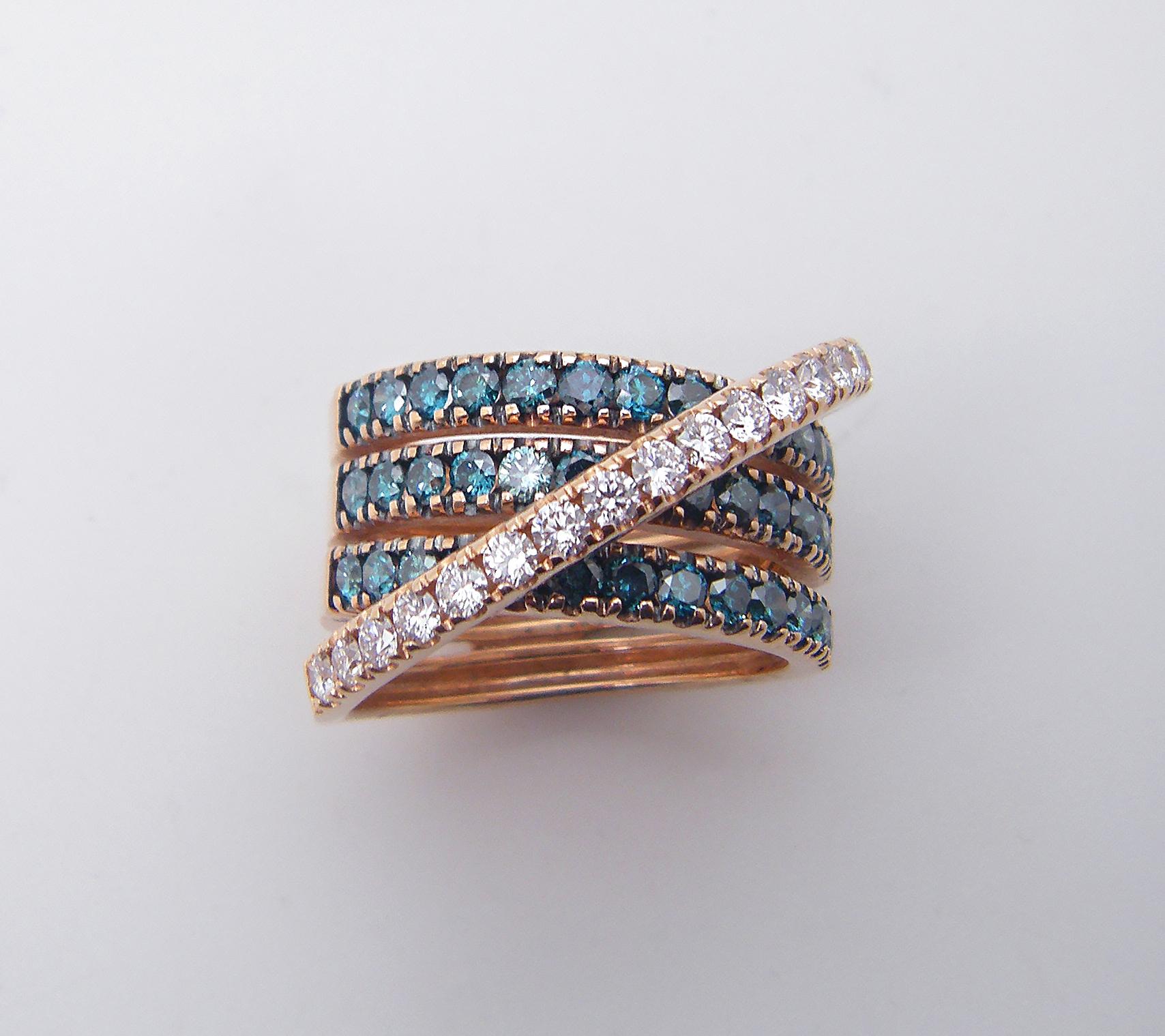 S.Georgios designer 18 Karat Two-Tone Rose Gold Brilliant Cut White and Blue Diamond Spiral Ring is all handmade in a unique design. The gorgeous ring features brilliant cut white diamonds total weight of 0.57 Carat and blue diamonds total weight of