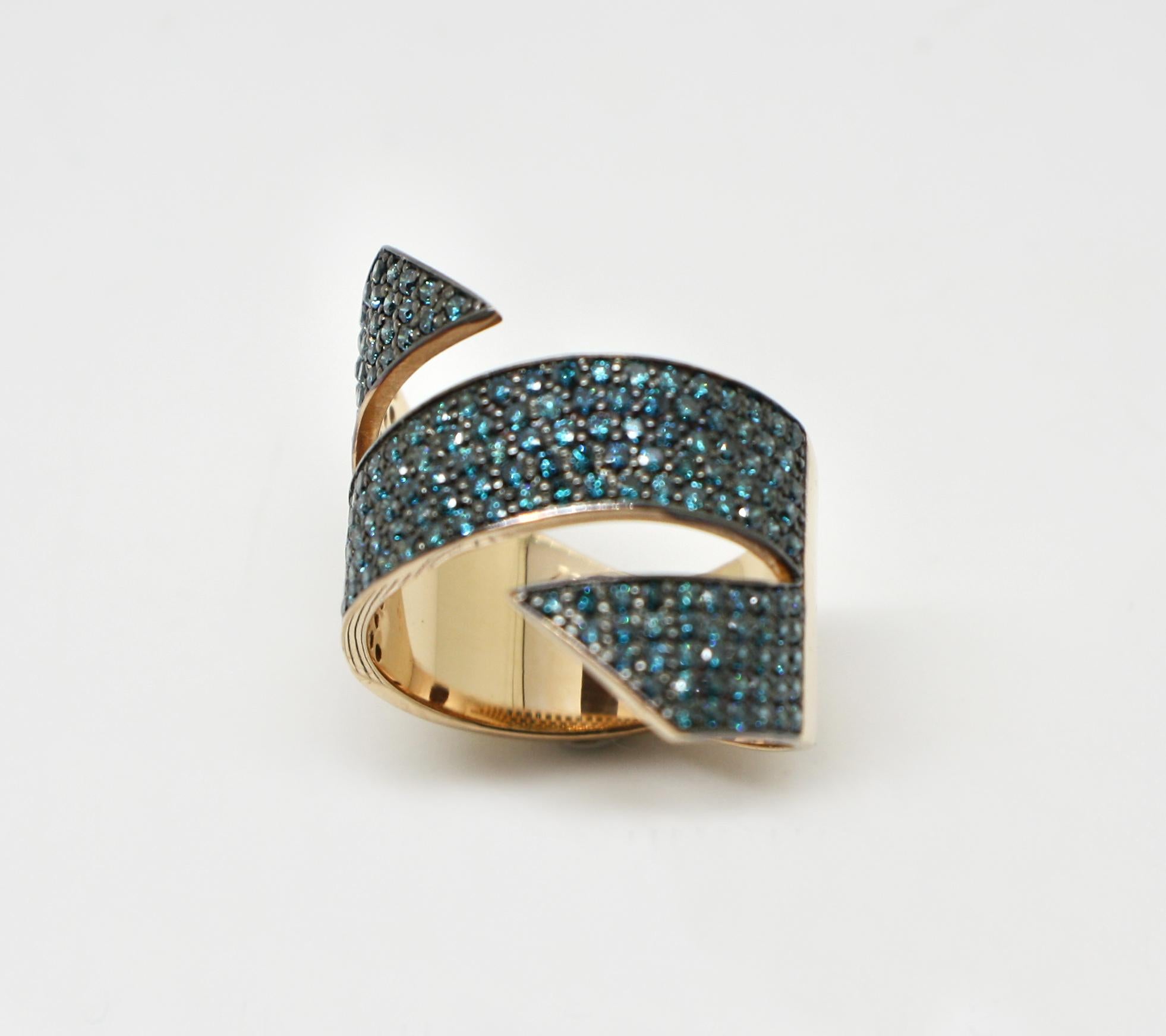 S.Georgios designer 18 Karat Rose Gold Wide Band Ring is all handmade in a unique two-tone look. The gorgeous wide band features brilliant-cut blue diamonds total weight of 1.52 Carat which is set in Black Rhodium prongs giving the ring a stunning