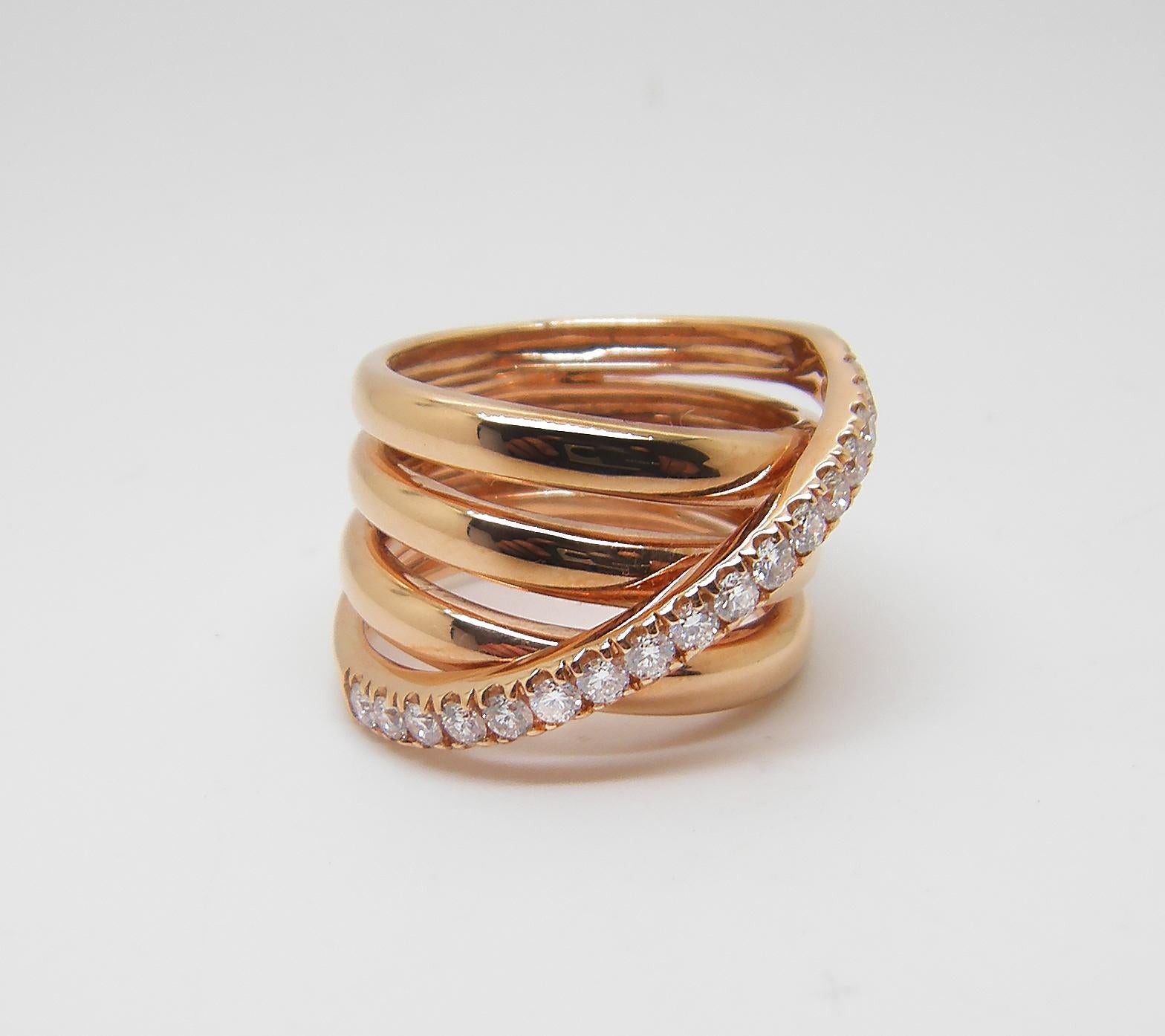 S.Georgios designer 18 Karat Rose Gold Diamond Wide Band Ring is all handmade in a unique design. The gorgeous ring features brilliant cut white diamonds total weight of 0.55 Carat and is made of a wide spiral design. 
We also make this beautiful