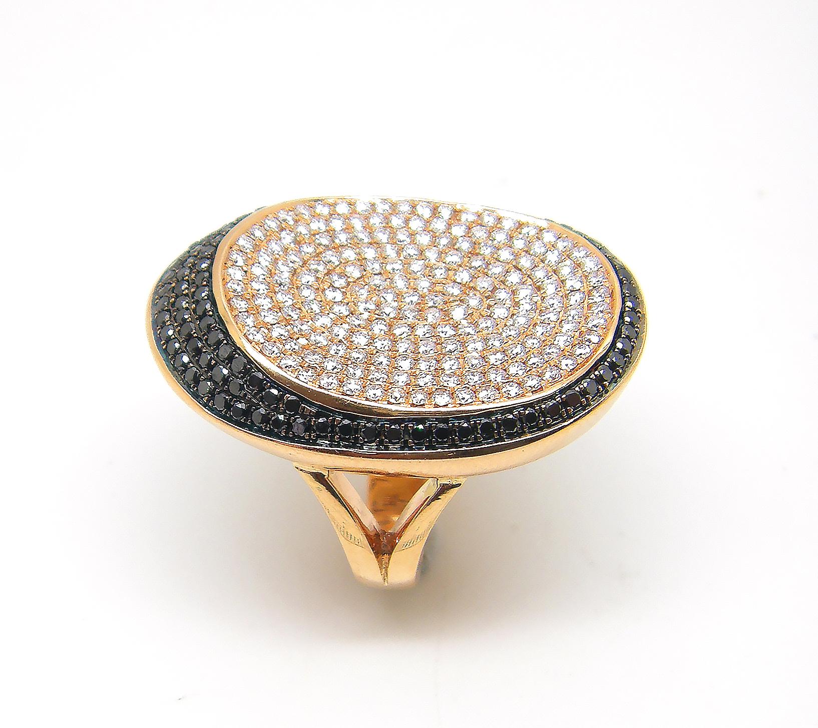 S.Georgios designer 18 Karat White Gold Brilliant Cut White and Black Diamond, wide band ring is all handmade in a unique long oval design. The gorgeous ring features brilliant cut white diamonds total weight of 1.52 Carat and black diamonds total