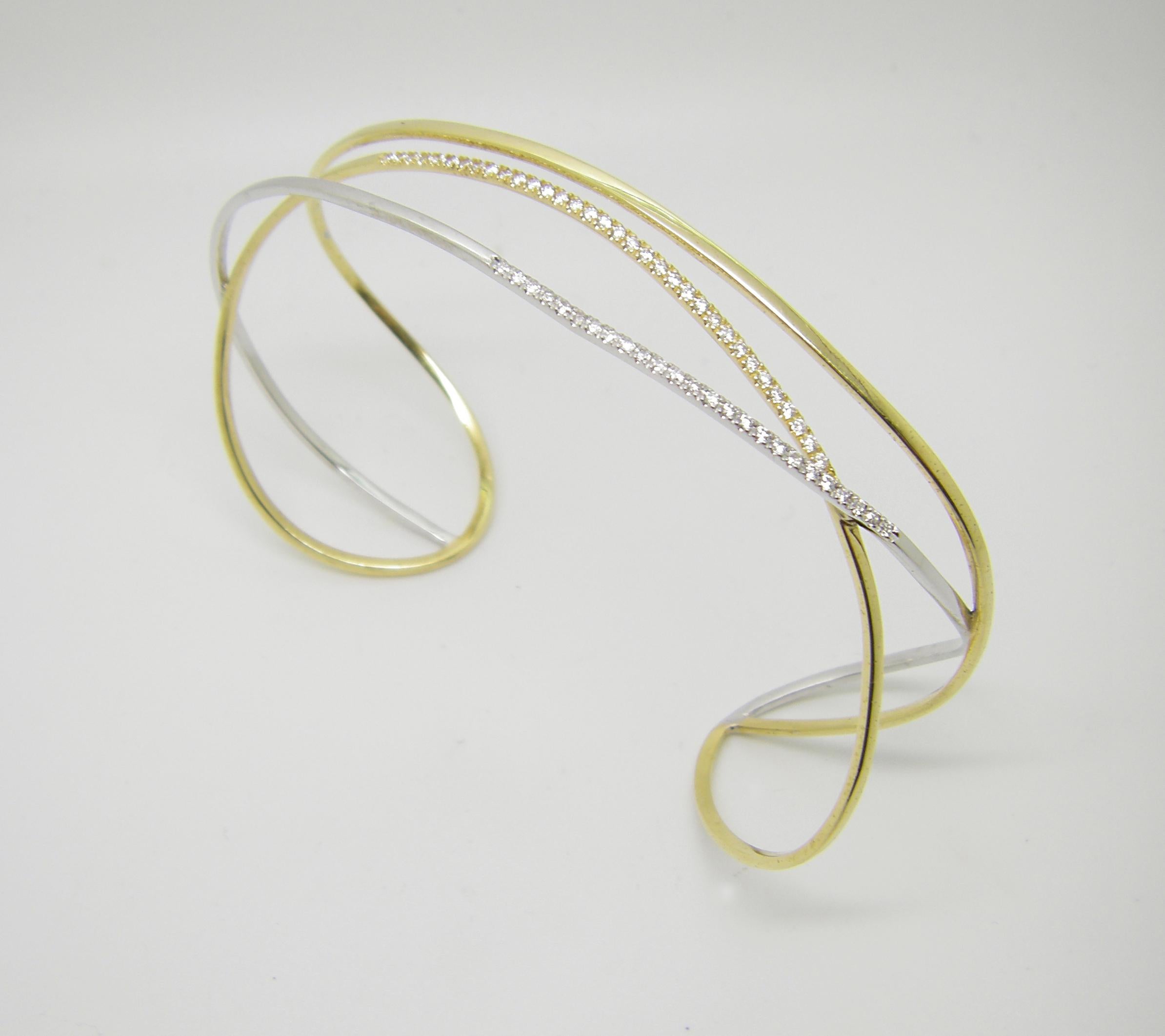This S.Georgios designer bangle cuff bracelet is custom made of white and yellow gold 18 karats. The gorgeous cuff has brilliant cut white diamonds total weight of 0.46 Carat set microscopically.
We also make this stunning piece in all white, all
