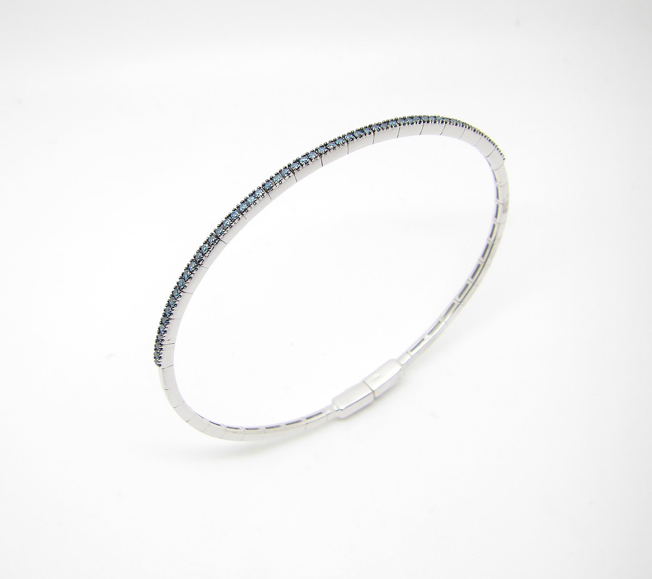 S.Georgios designer thin tennis bracelet bangle in solid white gold 18 karat and all handmade. The elegant Bracelet for everyday wear is custom made and has brilliant-cut blue diamonds total weight of 0.43 Carat. The gorgeous bangle has black