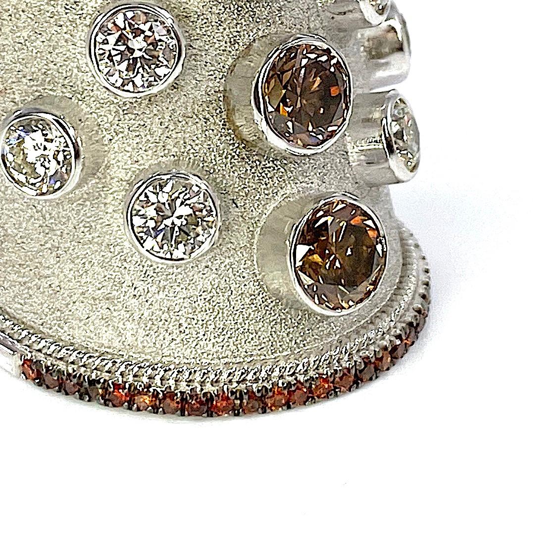 This unique S.Georgios designer 18 Karat Solid White Gold Wide Ring is all handmade in Byzantine style with a stunning  velvet background and it is set with 1.87 Carats of 3 Brilliant-cut Brown Diamonds in the center line and 0.35 Carats of
