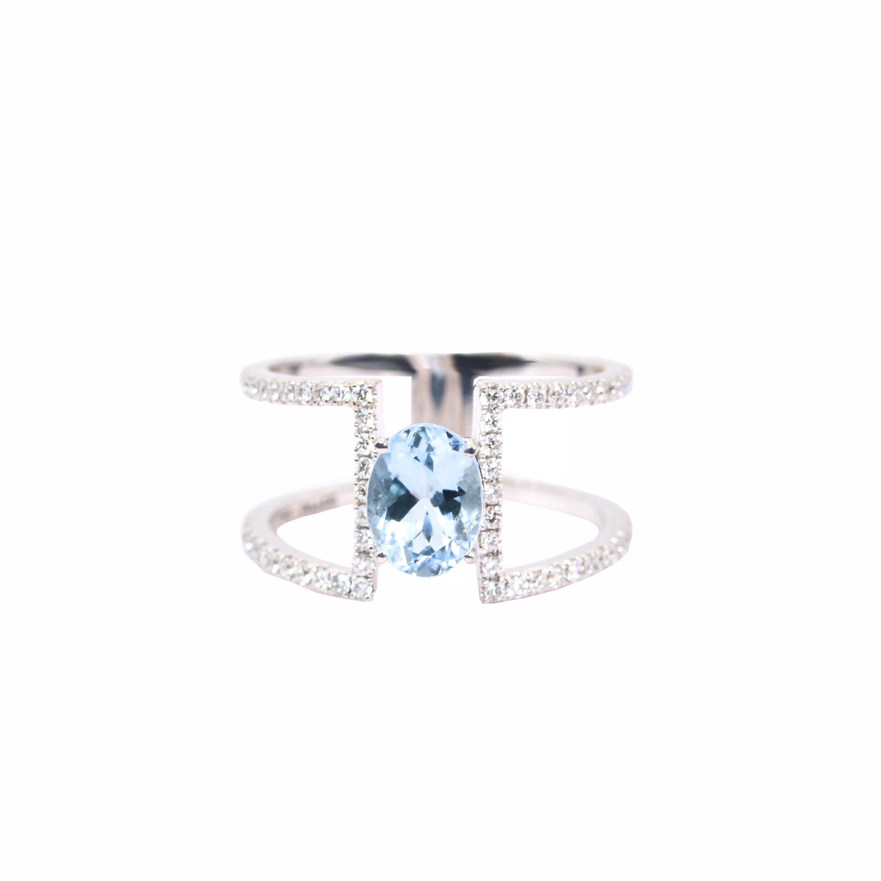S.Georgios designer presents an exquisite 18K White Gold Ring featuring a captivating 1.16-carat oval Aquamarine gemstone as its centerpiece, the design unites two sleek bands with the brilliance of the stone.Accentuated by 0.36 carats of shimmering