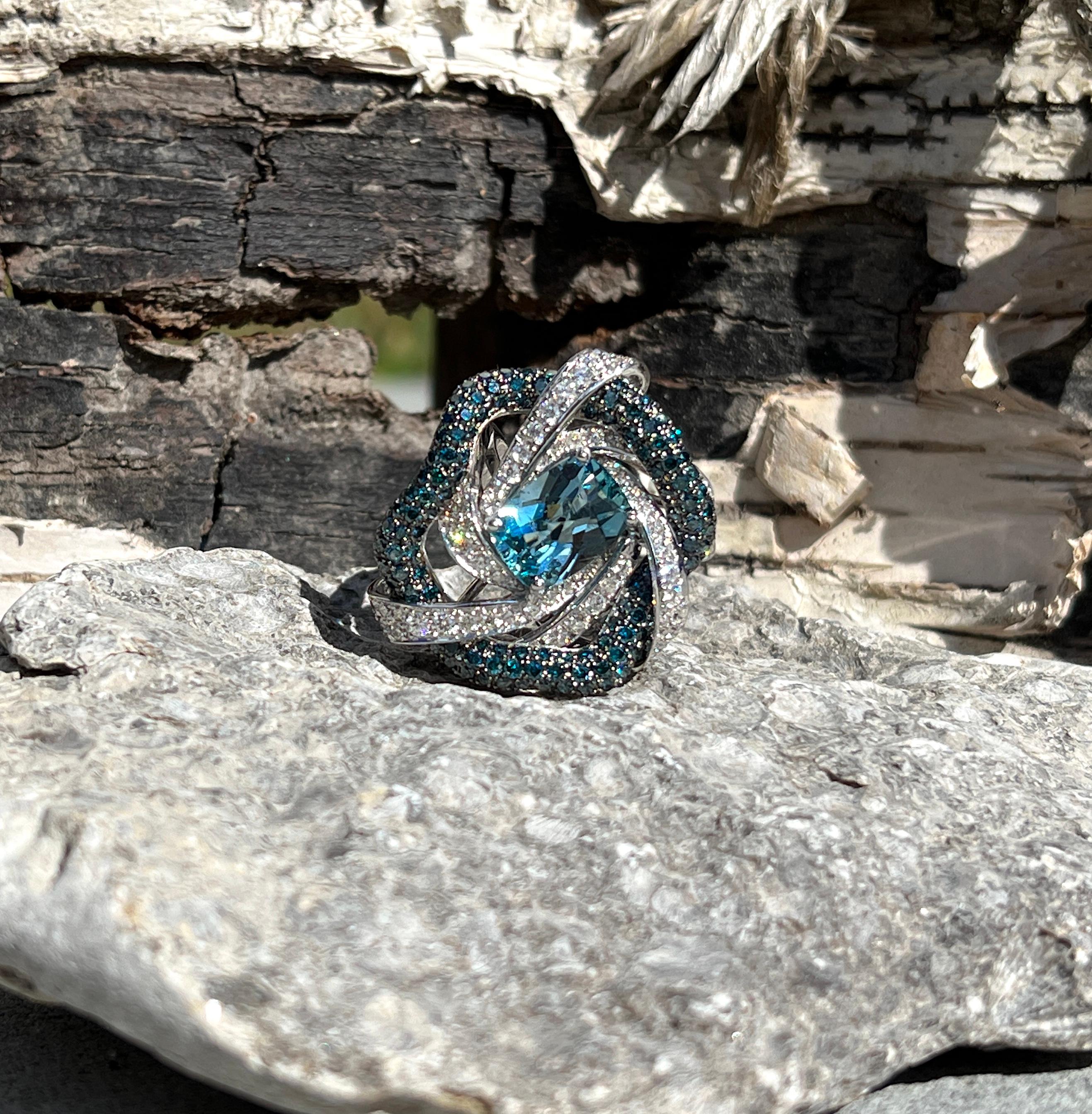 This large S. Georgios designer ring is made from 18 Karat White Gold and is all hand-made with microscopic settings. The gorgeous ring features 4.03 Carats of  Aquamarine in gorgeous color and 3.26 Carats of brilliant-cut Blue Diamonds and 3.04