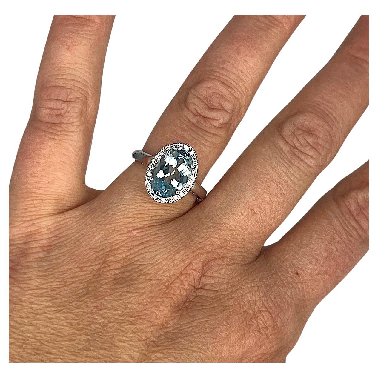 S.Georgios designer presents an oval shape 3.16 Carats Aquamarine ring with a White Diamond Bezel with a total weight of 0.20 Carat weight. This simple yet stunning ring is handmade from 18 Karat White gold in Athens Greece. The ring features a