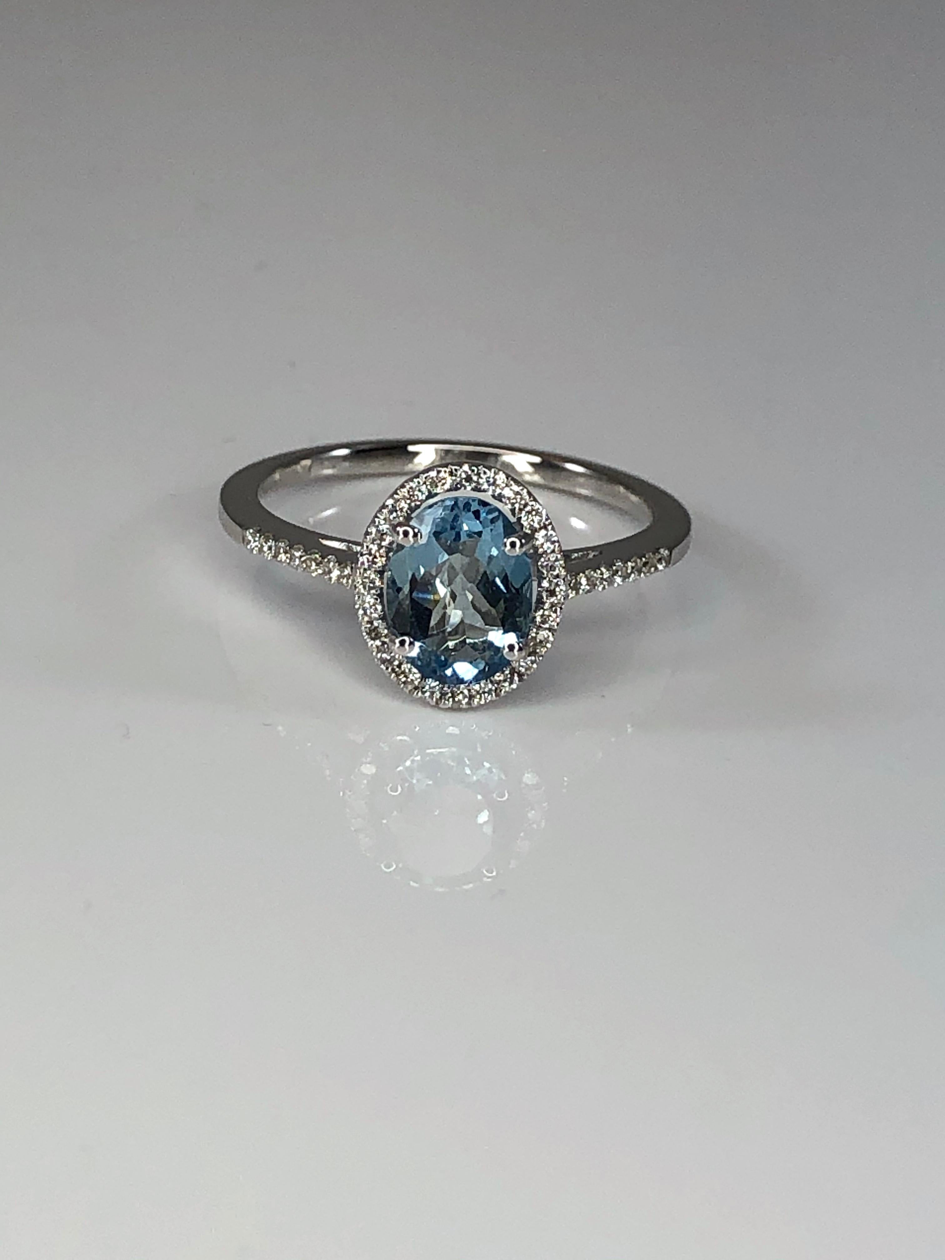 S.Georgios designer solitaire oval shape natural Aquamarine and diamond ring all handmade from 18 Karat White gold in Athens Greece. This gorgeous solitaire ring features a 1.11 Carat natural Aquamarine accompanied by Brilliant-cut White Diamonds