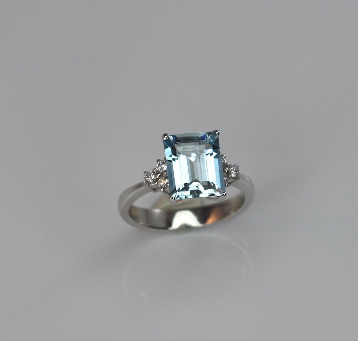 This gorgeous Aquamarine Ring designed by S.Georgios is all handmade in 18 Karat White gold and features a solitaire emerald cut Aquamarine of top quality the weight of 2,81 Carat. On the sides, we have set 6 Brilliant cut White Diamonds, the total