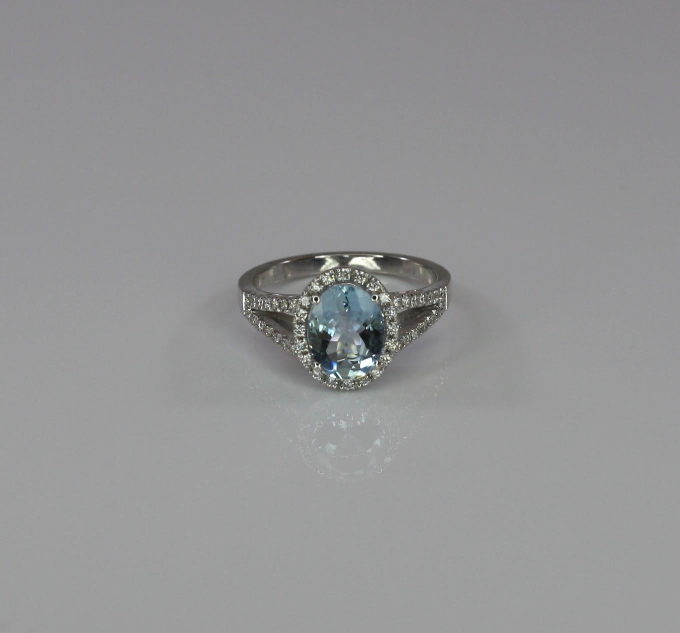 This is a gorgeous Aquamarine rosette ring from S.Georgios designs. The stunning ring was handmade from 18 Karat White gold in Athens Greece and features 1.46 Carat Aquamarine in oval cut, accompanied by Brilliant-cut White Diamonds total weight of