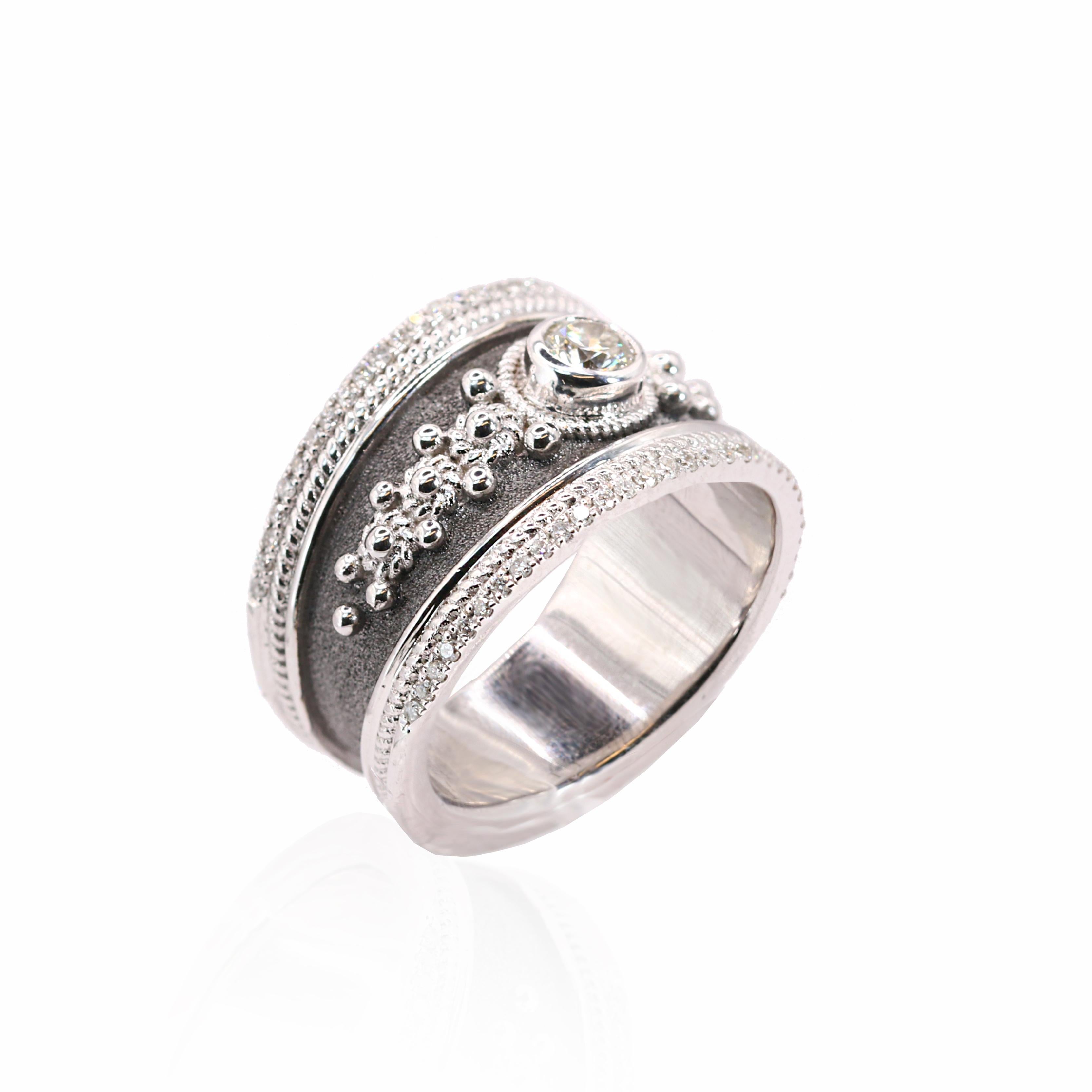 The is gorgeous S.Georgios designer 18 Karat Solid White Gold Ring all handmade in Greece in an elegant look inspired by Byzantine era. This ring is heavily decorated with diamonds and granulation work - beads and twisted wires. Ring features center