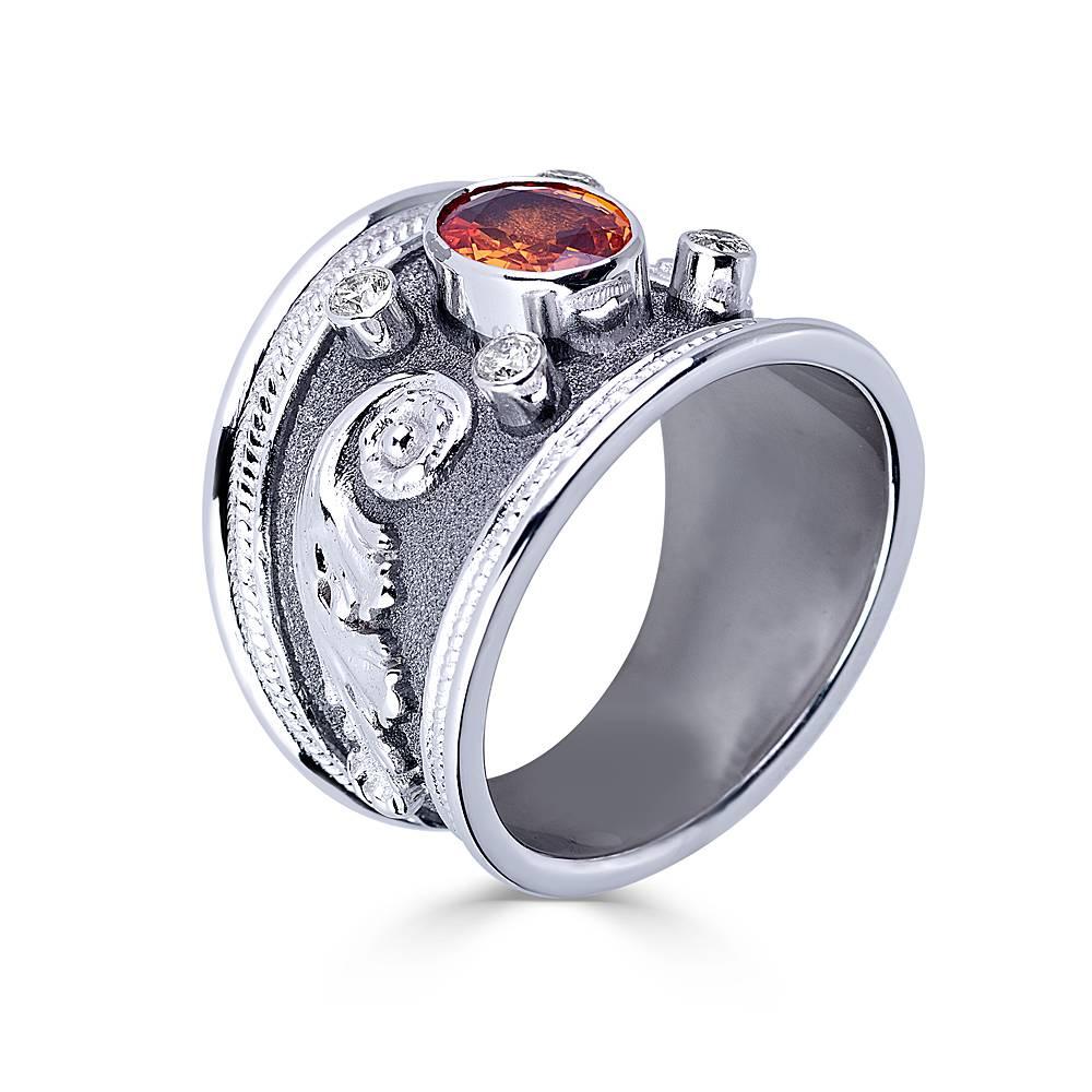S.Georgios designer 18 Karat Solid White Gold Ring is all handmade with Byzantine granulation workmanship done all microscopically and has a unique velvet look on the background finished with Black Rhodium. The ring features an oval-cut Orange