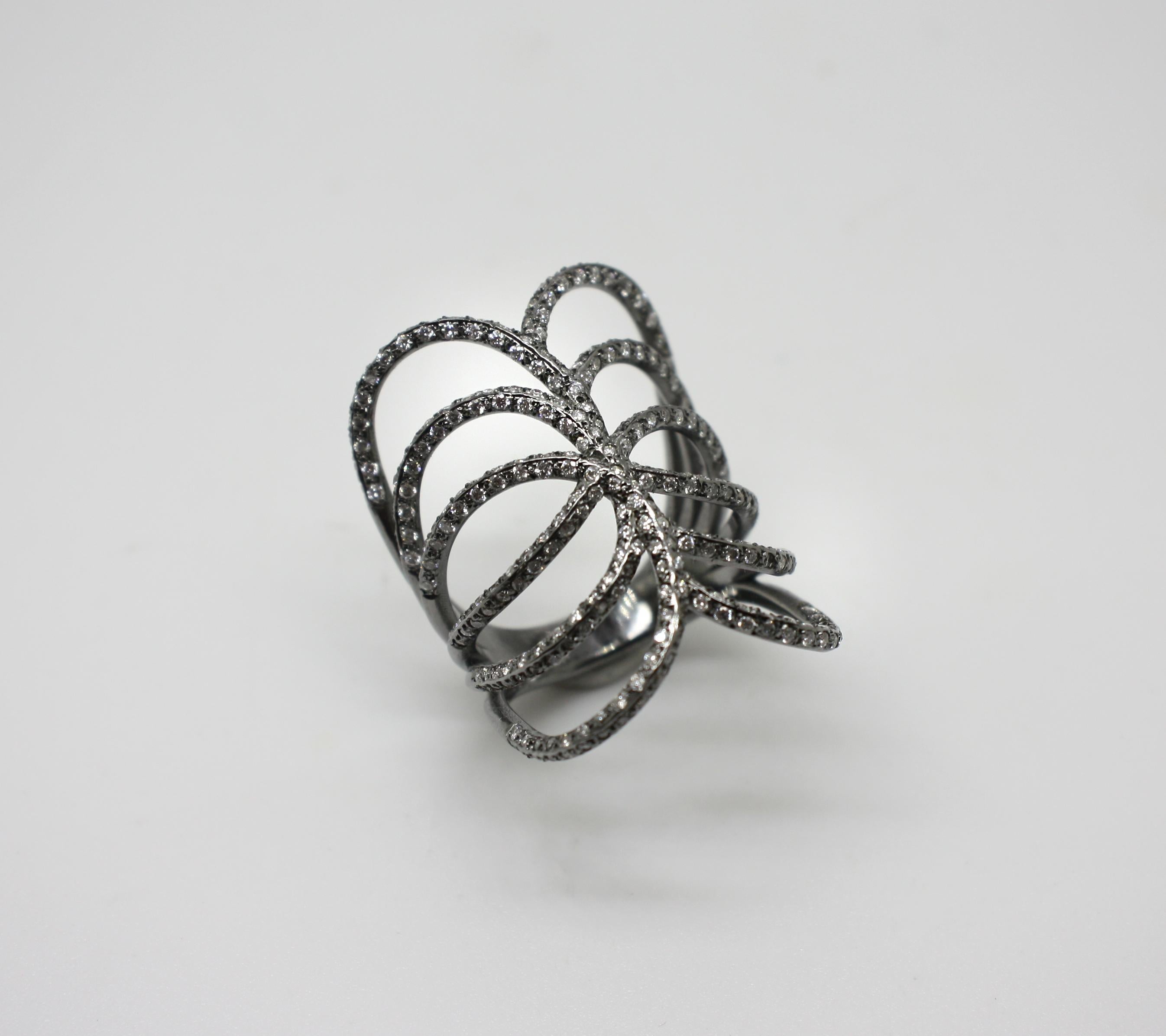 S.Georgios designer 18 Karat White Gold Black Rhodium Diamond Ring is all handmade in a unique design. The gorgeous ring features brilliant cut white diamonds total weight of 1.36 Carat is made of a wide spiral design. 
We also make this beautiful