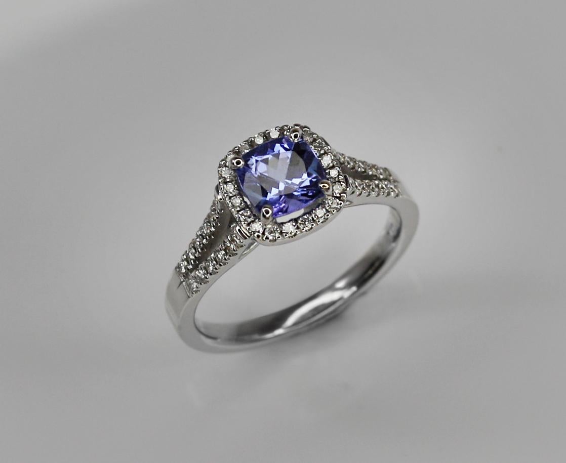 This S.Georgios designer Ring is all hand-made in White Gold 18 Karat. It features a solitaire cushion cut natural Tanzanite the weight 1.22 Carat and natural white brilliant cut diamonds total weight of 0.27 Carat. This is a gorgeous and classic