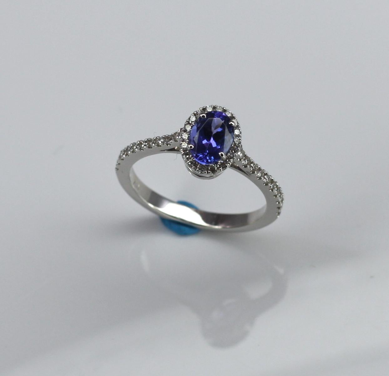 S.Georgios designer Ring is all hand-made in White Gold 18 Karat. This beautiful band features a solitaire cushion cut natural Tanzanite the weight 1.22 Carat and natural white brilliant cut diamonds total weight of 0.27 Carat. The gorgeous and