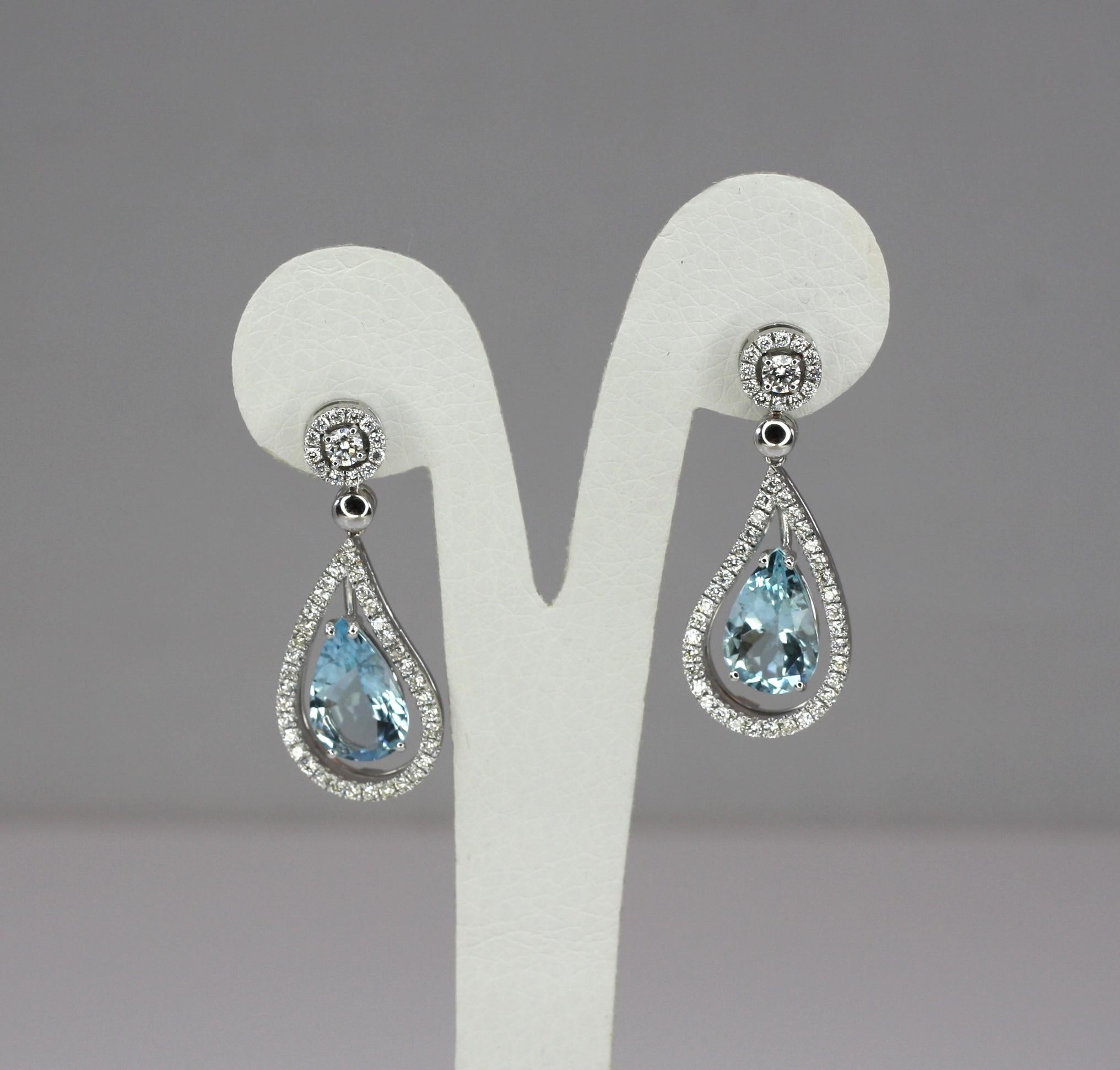 S.Georgios designer dangle Earrings are in 18 Karat white gold with two gorgeous natural Pear Shape Aquamarines and pure white VVS2 color F brilliant cut Diamonds. These beautiful dangle earrings have brilliant-cut Diamonds total weight of 1.51