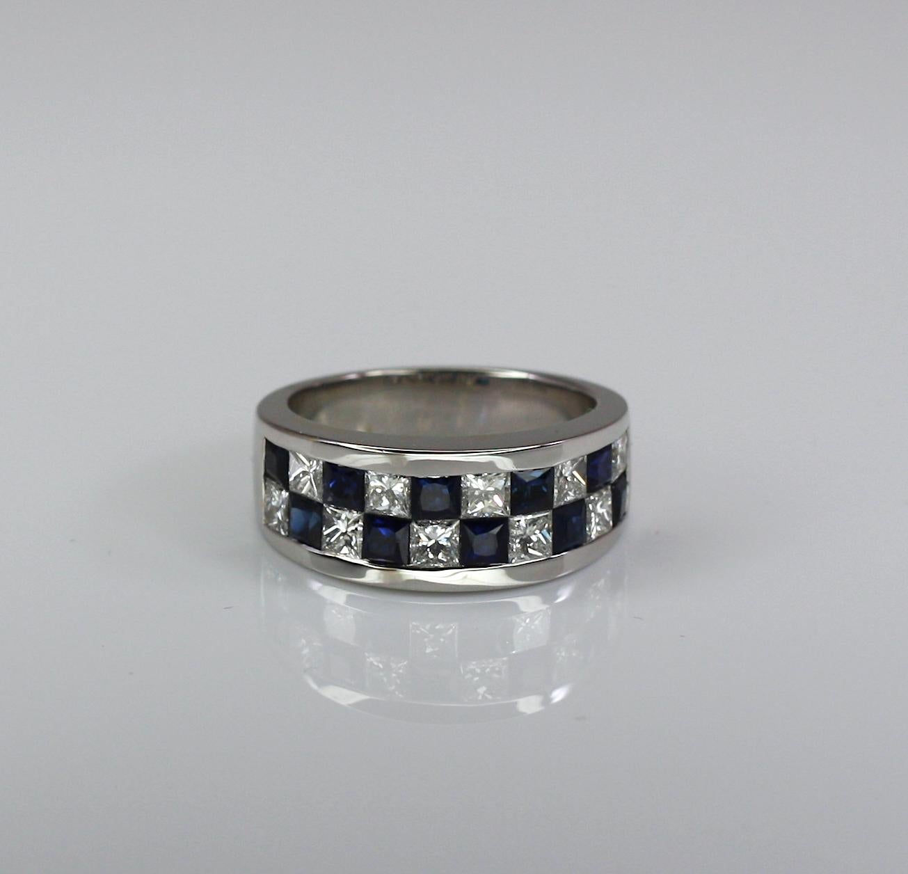 S.Georgios designer invisible set band ring crafted from 18 Karat white gold. This gorgeous ring is set with princess-cut Blue Sapphires with a total weight of 1.72 Carat and Diamonds total weight of 1.35 Carat. 
The stunning ring is outstanding in